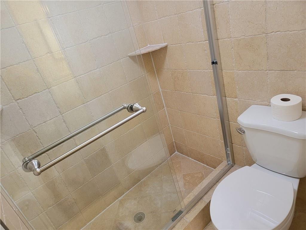 1001 SE 6TH Avenue, #127, Deerfield Beach, Deerfield Beach, FL 33441 Tiled shower enclosure with a clear glass door and brushed nickel hardware