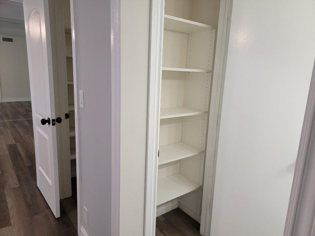 1001 SE 6TH Avenue, #127, Deerfield Beach, Deerfield Beach, FL 33441 Built-in shelving with adjustable white shelves, flat-panel interior doors, and wood-finish flooring