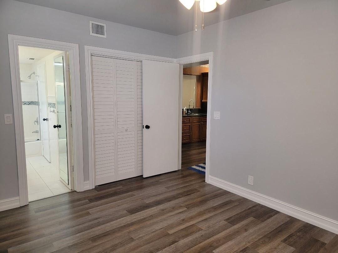 1001 SE 6TH Avenue, #127, Deerfield Beach, Deerfield Beach, FL 33441 Wood-finish flooring, light gray wall paint, and white trim