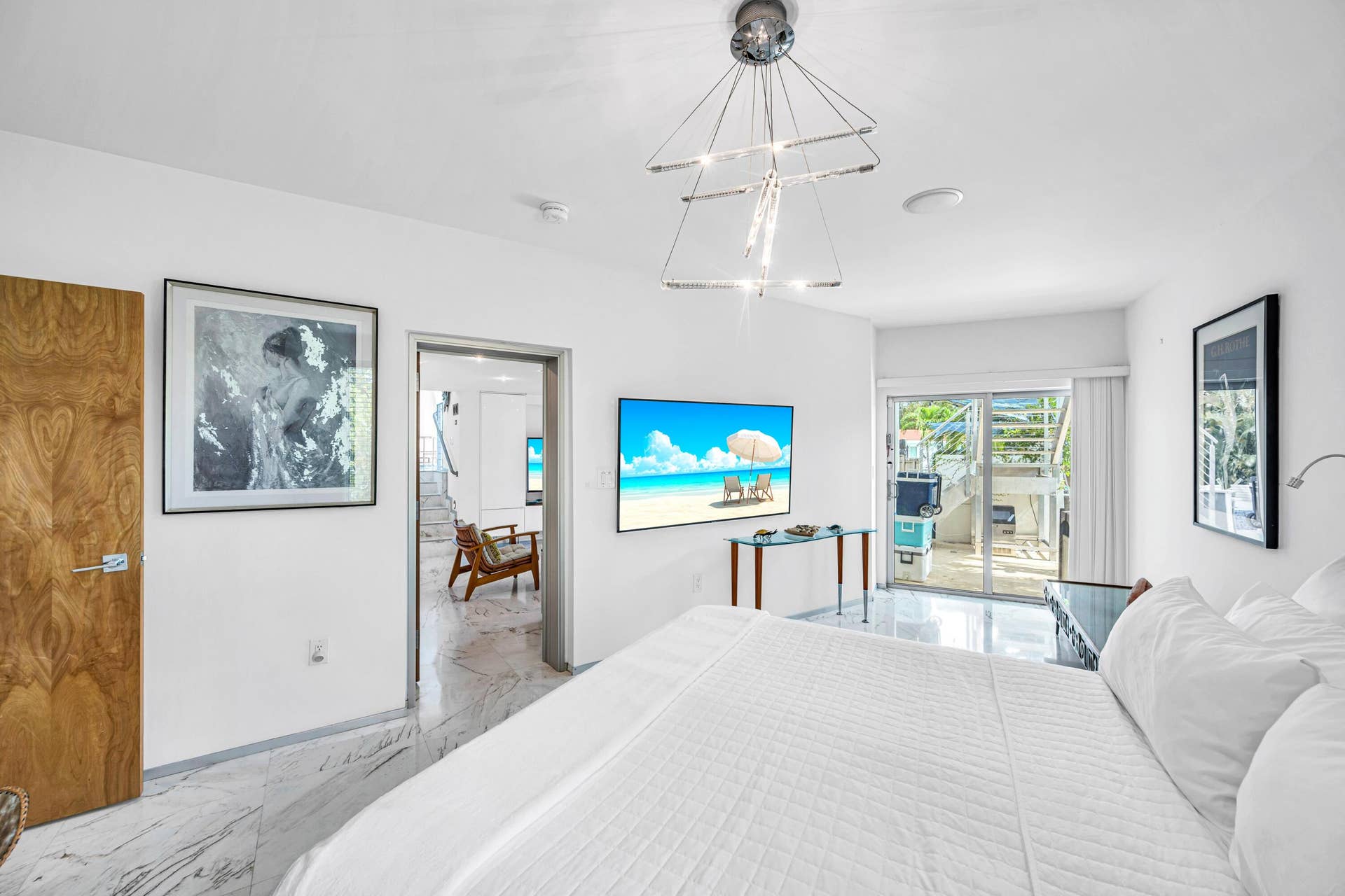 510 SW 18th Avenue, Fort Lauderdale, FL 33312 White walls, marble-finish flooring, wood-finish door, and a modern chandelier