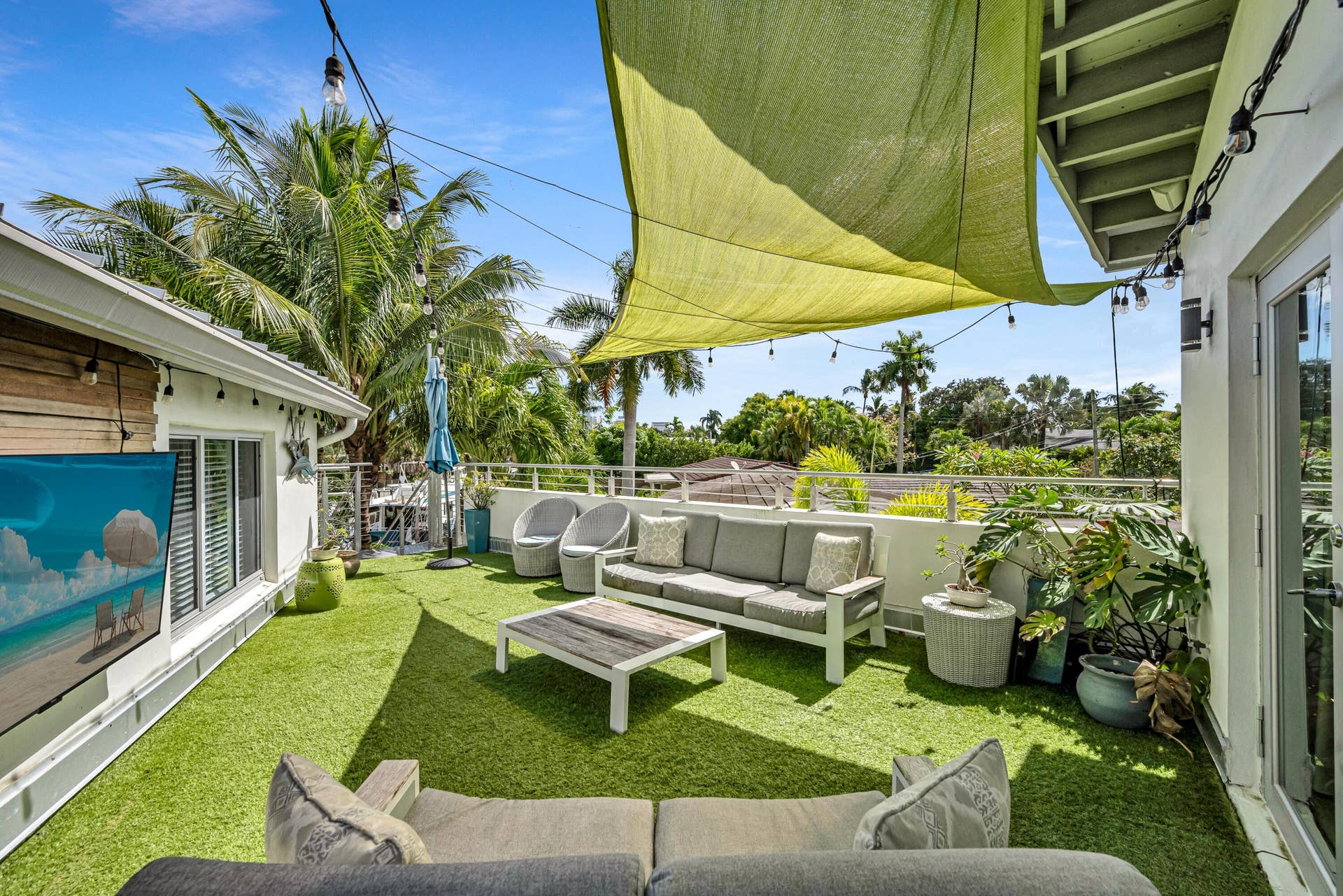 510 SW 18th Avenue, Fort Lauderdale, FL 33312 Rooftop deck featuring artificial turf, a light-colored sunshade, string lighting, and exterior French doors