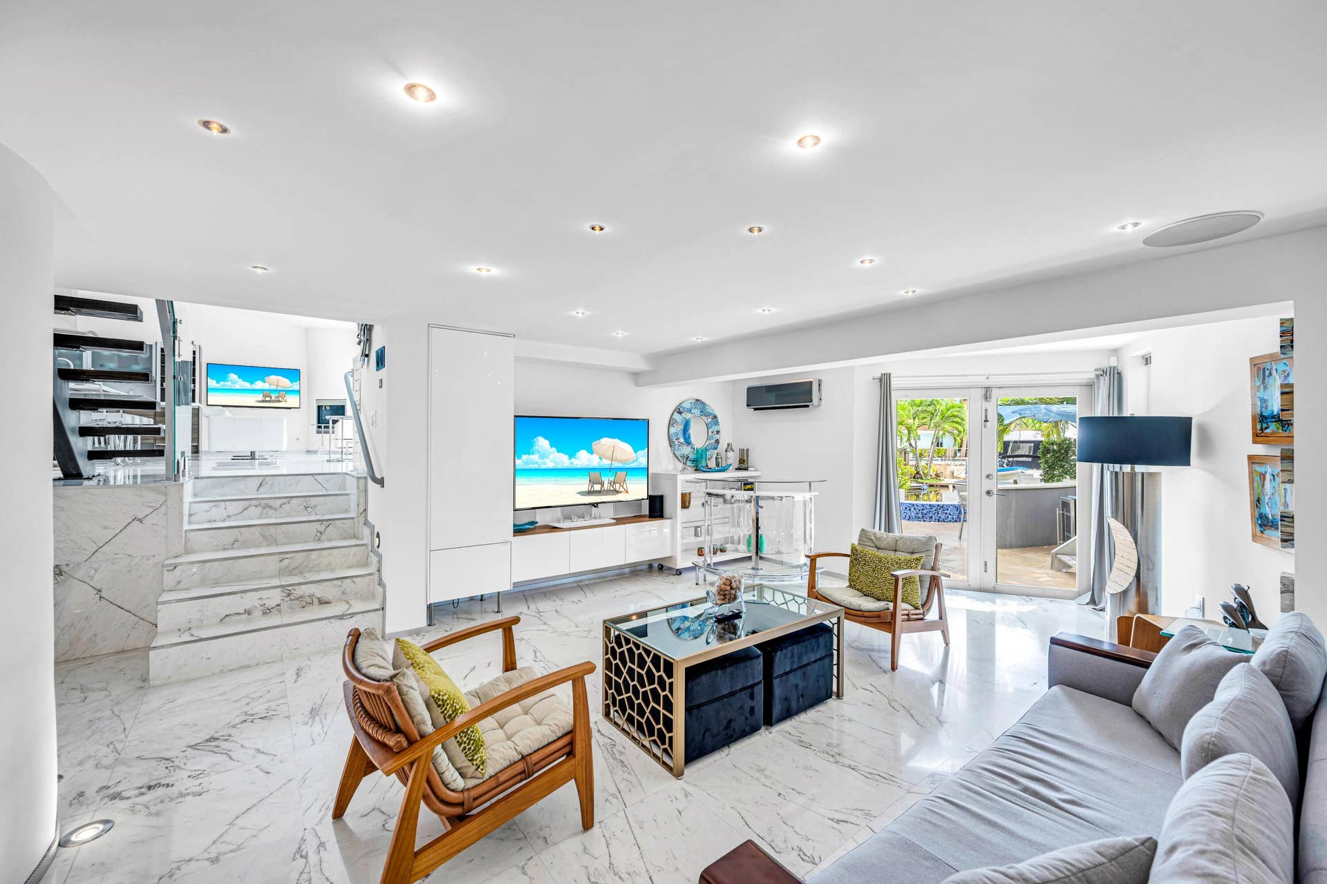 510 SW 18th Avenue, Fort Lauderdale, FL 33312 Recessed lighting, marble-style flooring, white walls, built-in media console, and glass doors opening to an exterior area