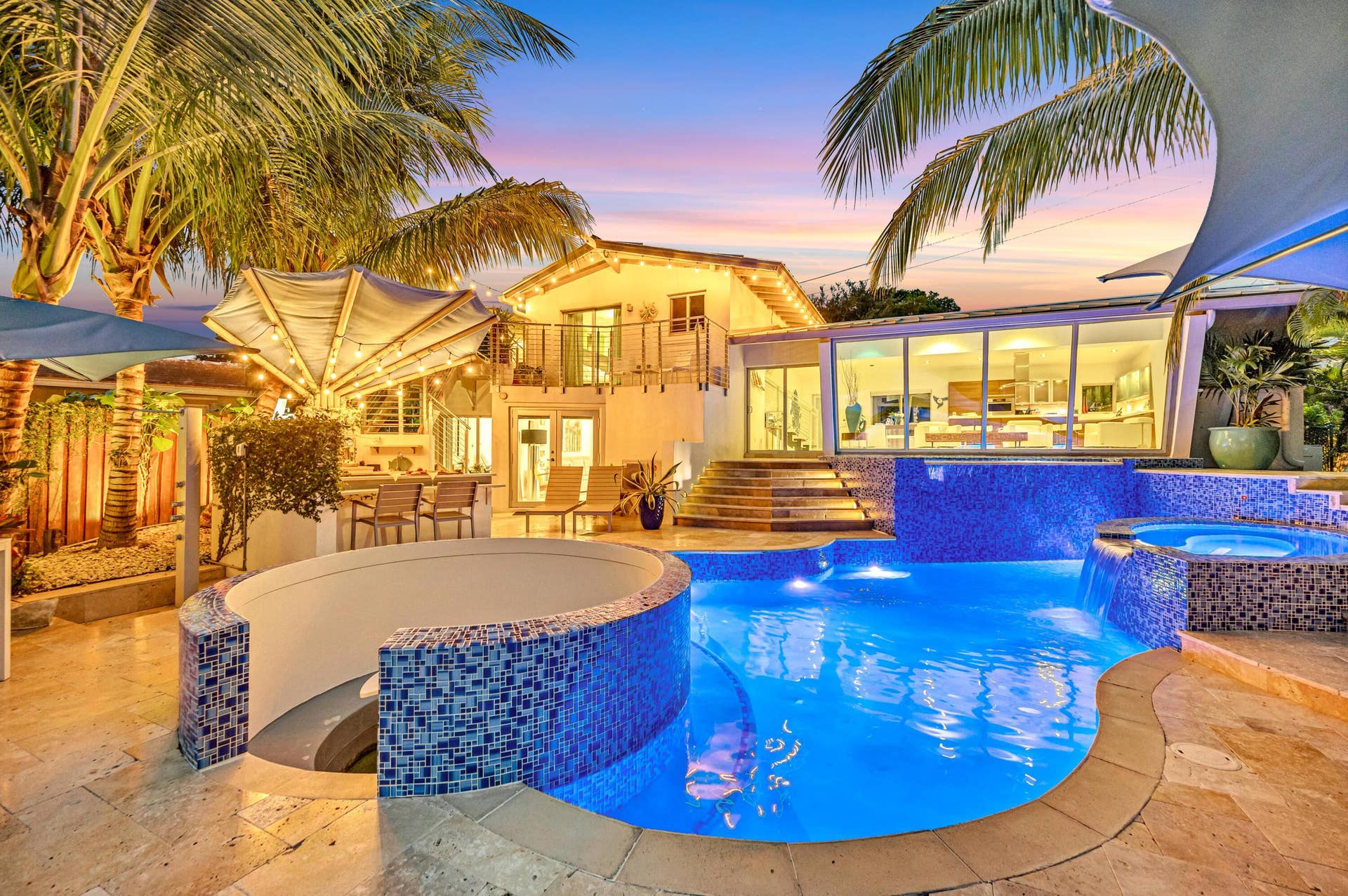 510 SW 18th Avenue, Fort Lauderdale, FL 33312 Resort-style backyard featuring a multi-level pool with integrated spa, waterfall features, and blue mosaic tile accents