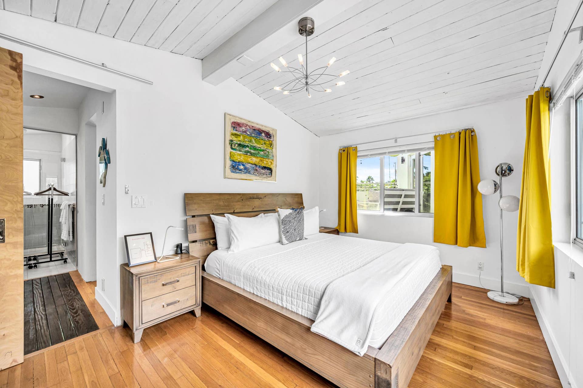 510 SW 18th Avenue, Fort Lauderdale, FL 33312 Vaulted wood-plank ceiling, wood-finish flooring, large window, and modern chandelier