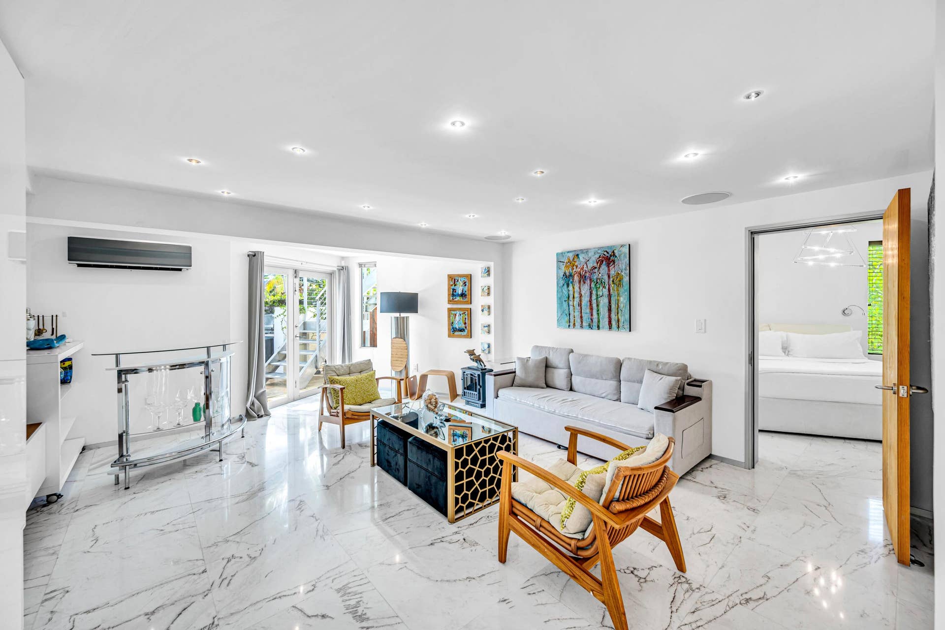 510 SW 18th Avenue, Fort Lauderdale, FL 33312 Recessed lighting, large format stone-finish tile flooring, wall-mounted air conditioning unit, glass sliding doors, and a wood door frame