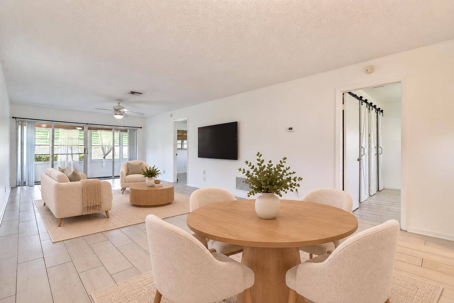 450 BLUEBIRD Lane, Delray Beach, FL 33445 Open-concept living area with light-toned flooring and a ceiling fan