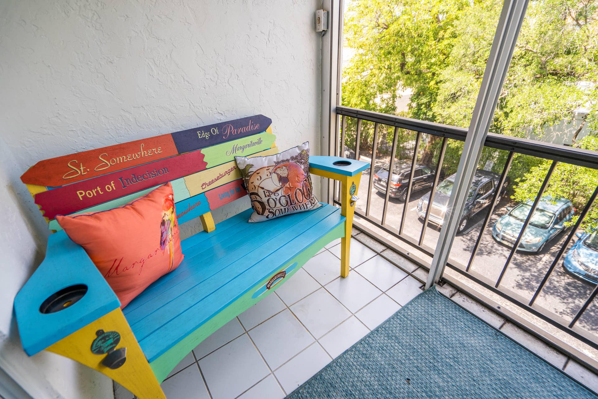 Enclosed balcony with white tile flooring and black metal railings