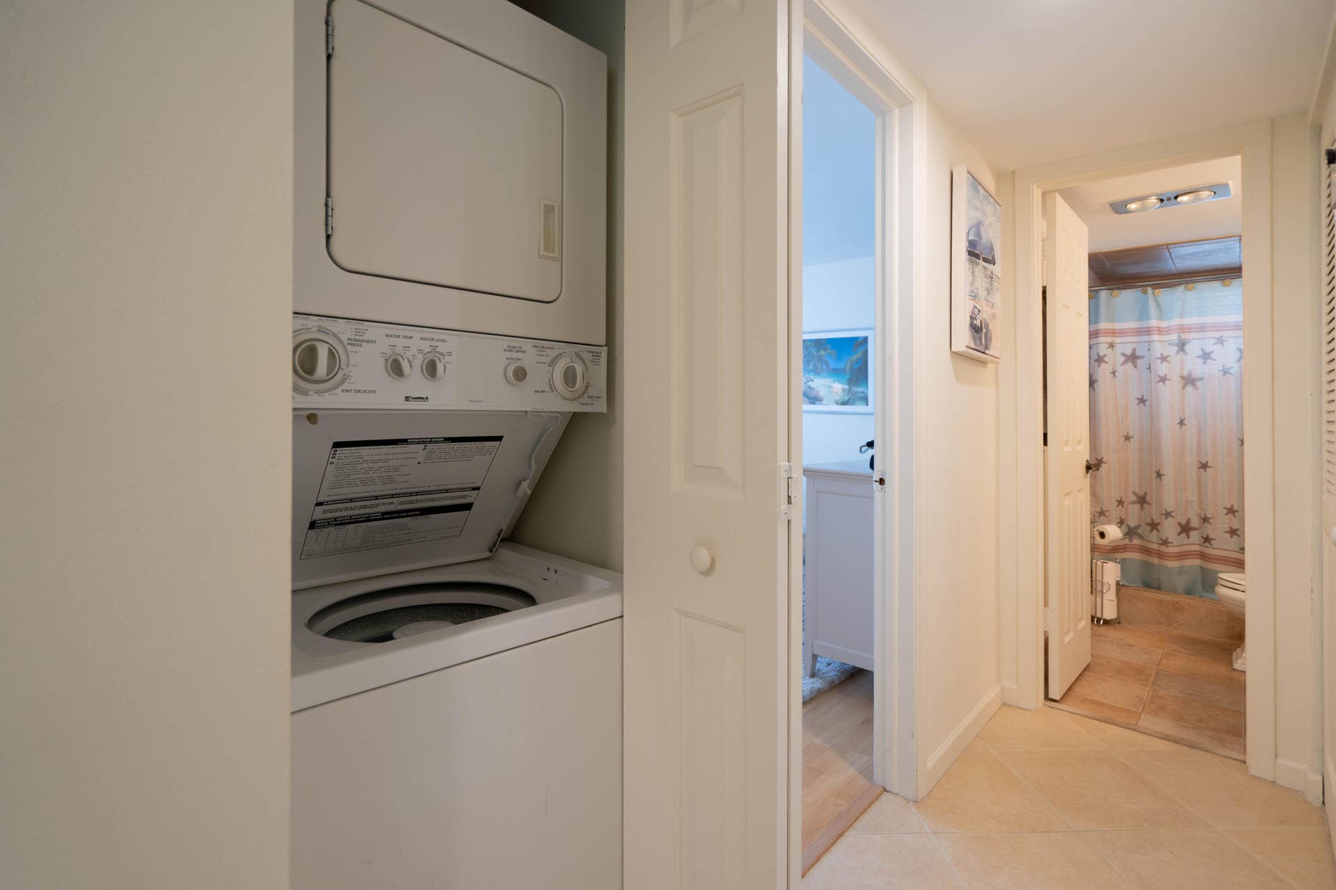 Stackable washer and dryer unit, solid panel doors, and tile flooring