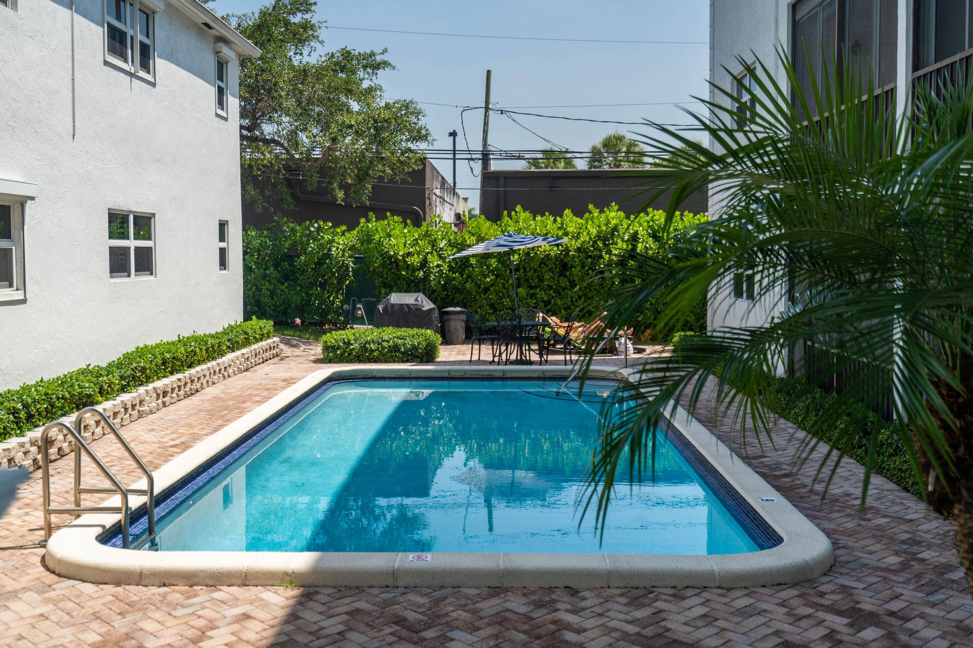 Rectangular swimming pool featuring a tiled waterline