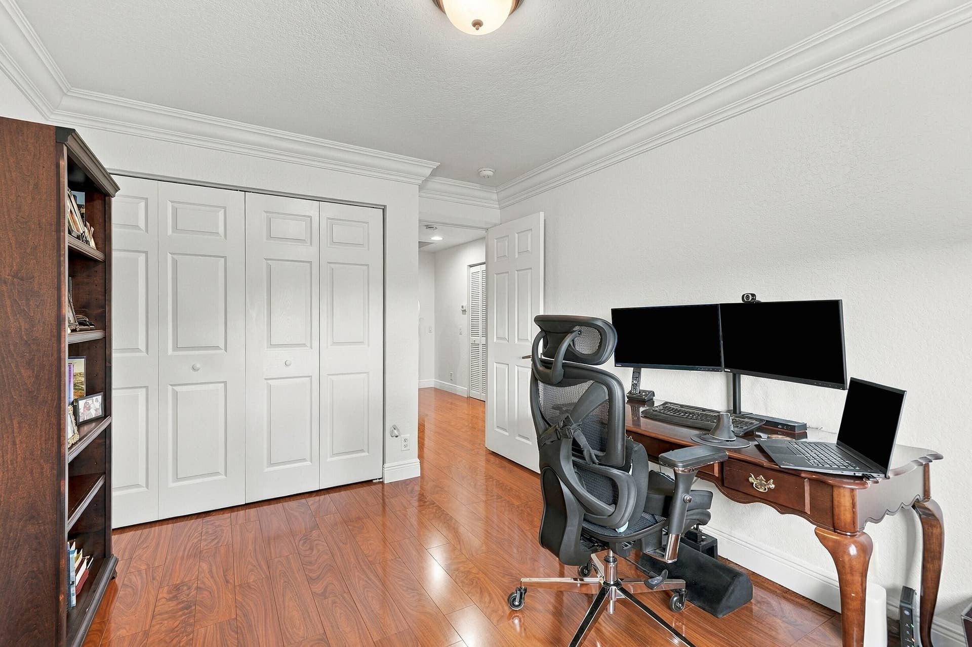 1020 Lavender Circle, Weston, FL 33327 Wood-finish flooring with white walls and a multi-paneled bi-fold closet