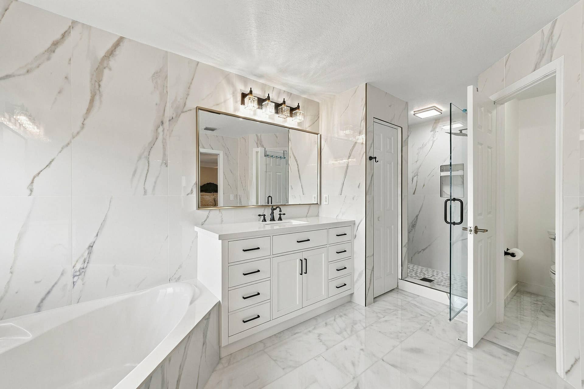 1020 Lavender Circle, Weston, FL 33327 White vanity with a quartz countertop, frameless mirror, and modern light fixture