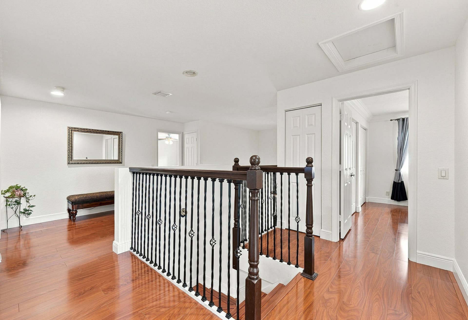 1020 Lavender Circle, Weston, FL 33327 Hardwood flooring throughout, white walls, dark wood and wrought iron staircase railing, recessed lighting, and white paneled doors