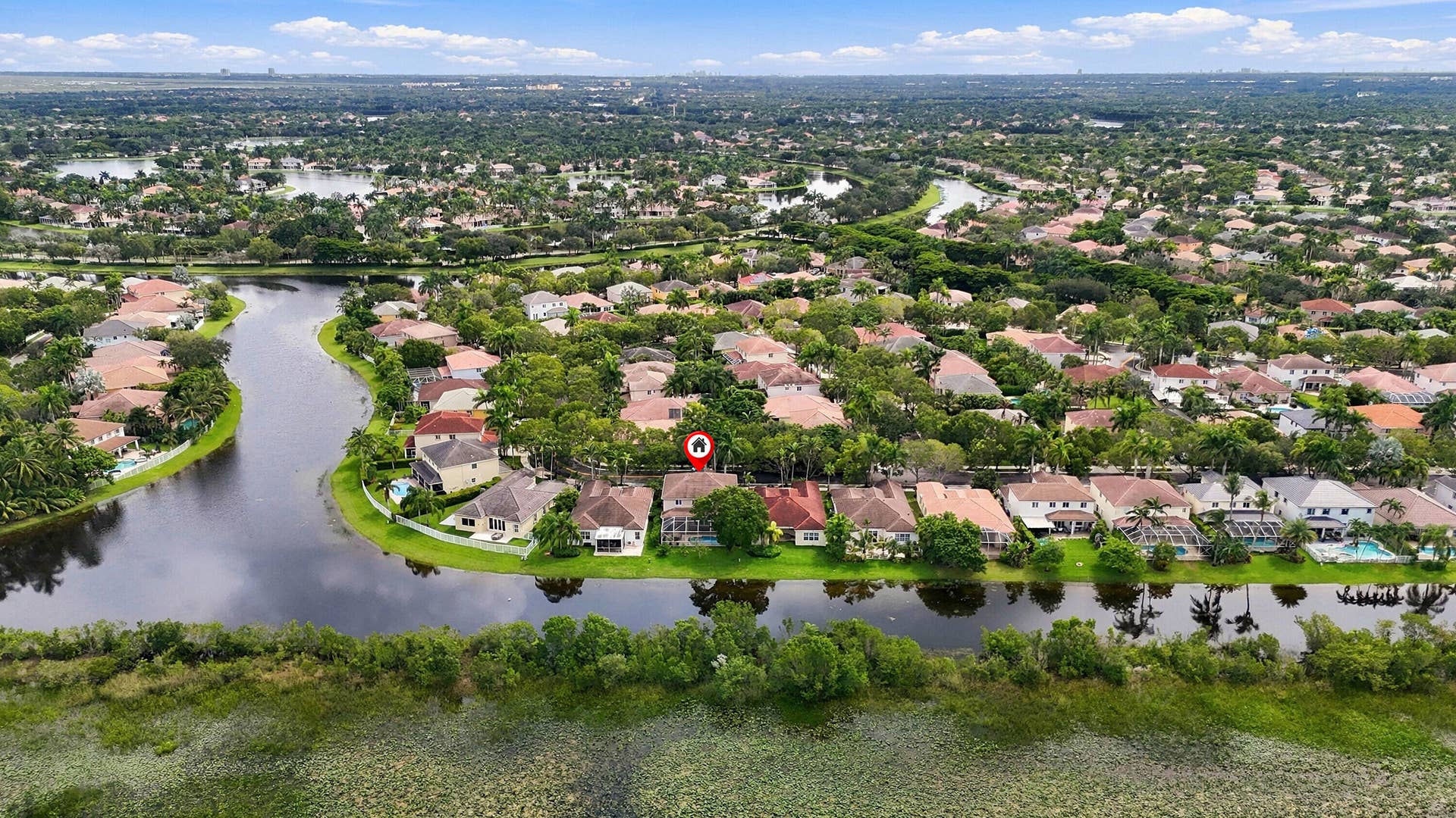 1020 Lavender Circle, Weston, FL 33327 Waterfront property with residential surroundings and extensive green landscaping