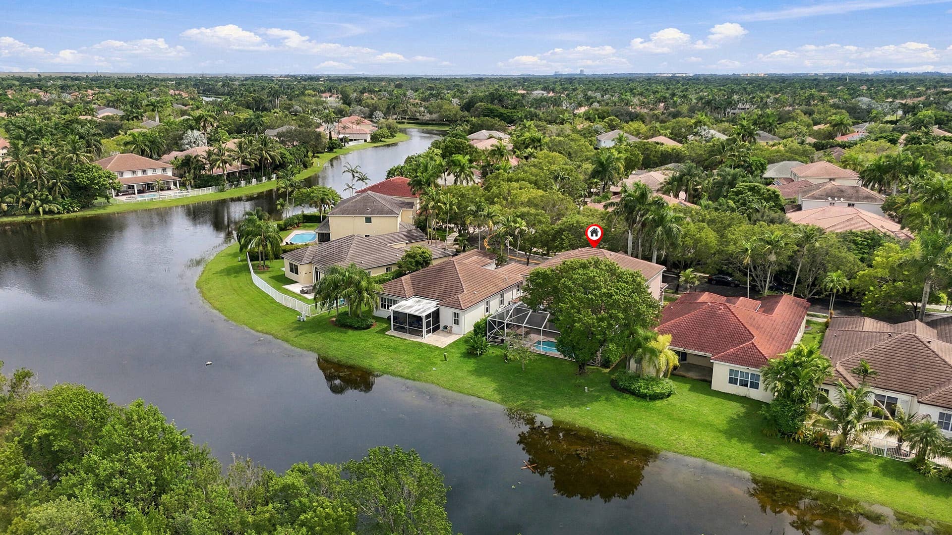 1020 Lavender Circle, Weston, FL 33327 Waterfront property with private pool, screened patio, and mature landscaping