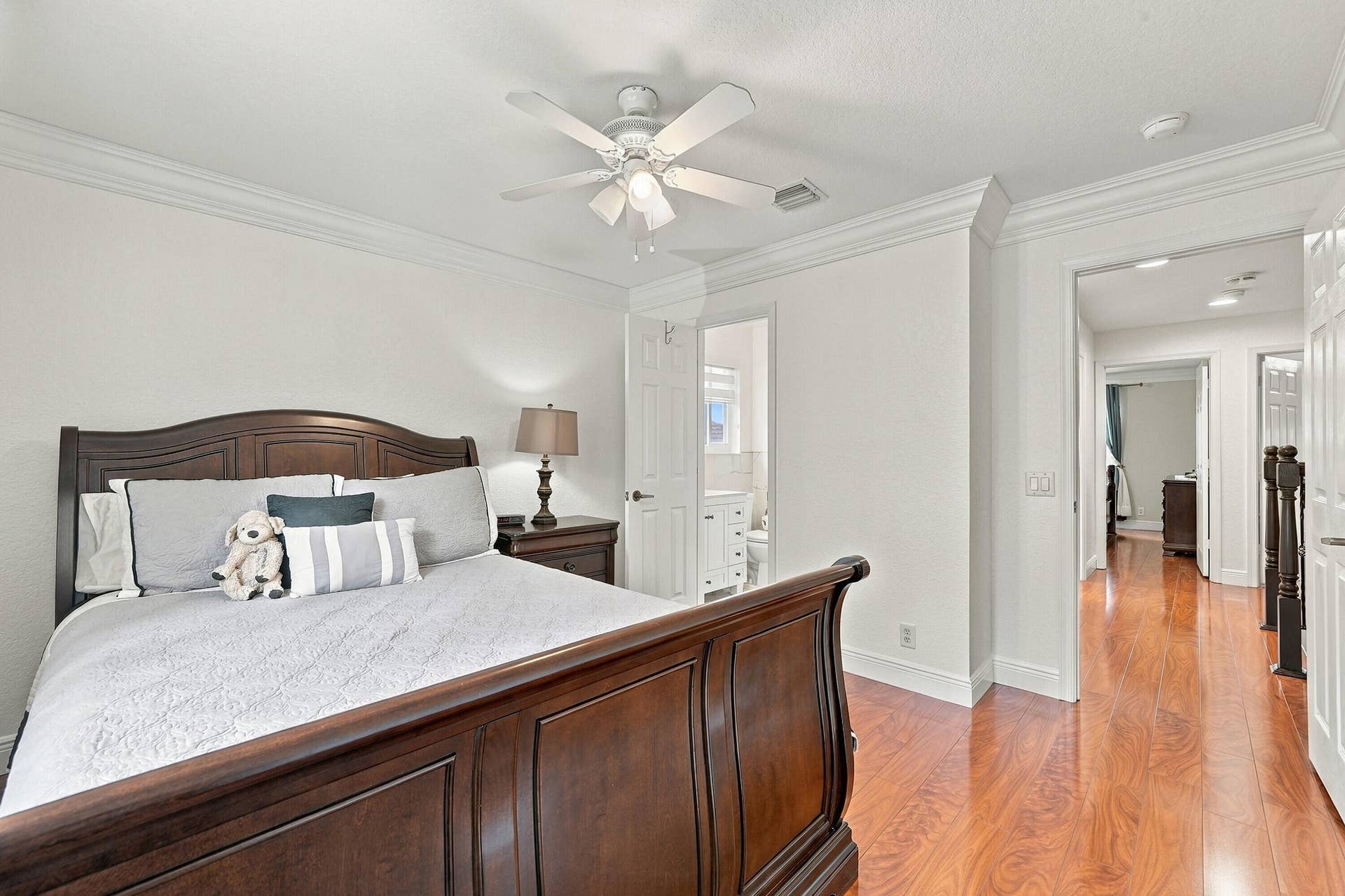 1020 Lavender Circle, Weston, FL 33327 Wood-finish flooring throughout, crown molding, ceiling fan, and white painted walls
