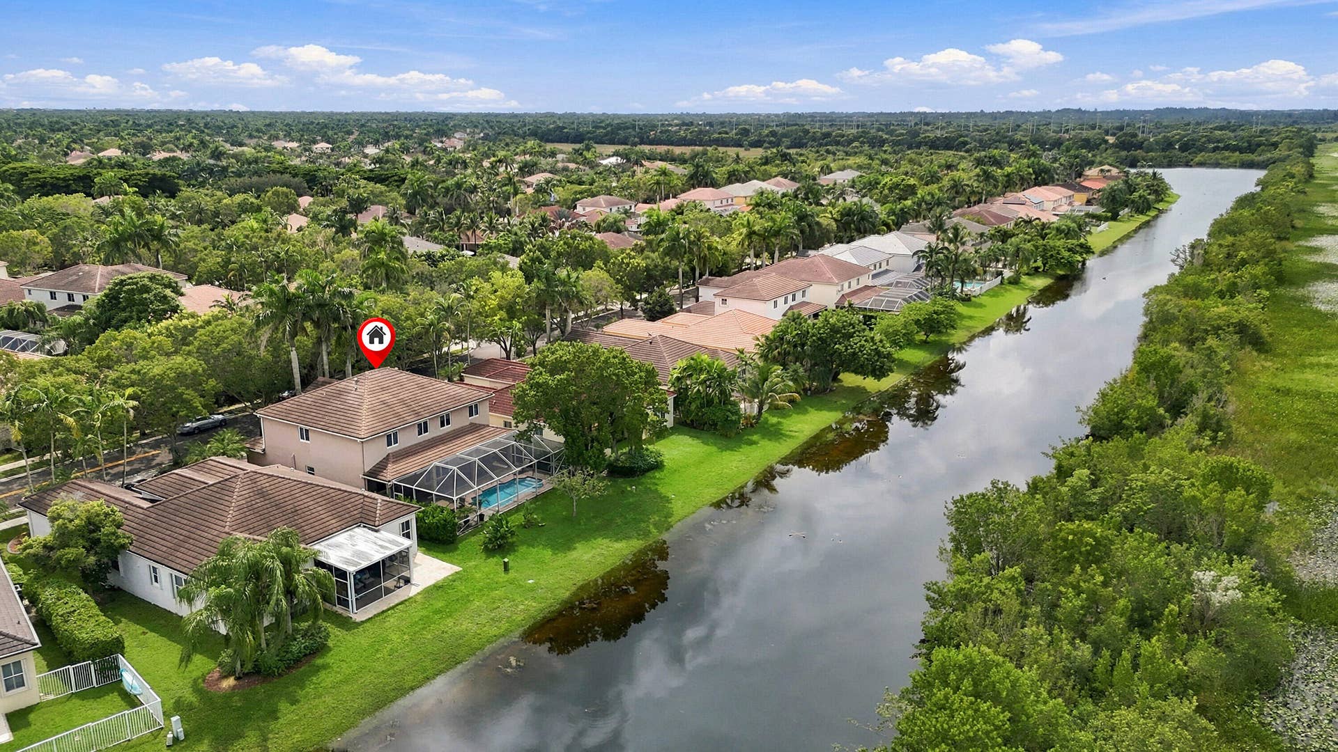 1020 Lavender Circle, Weston, FL 33327 Two-story residence with a screened pool enclosure and an expansive backyard