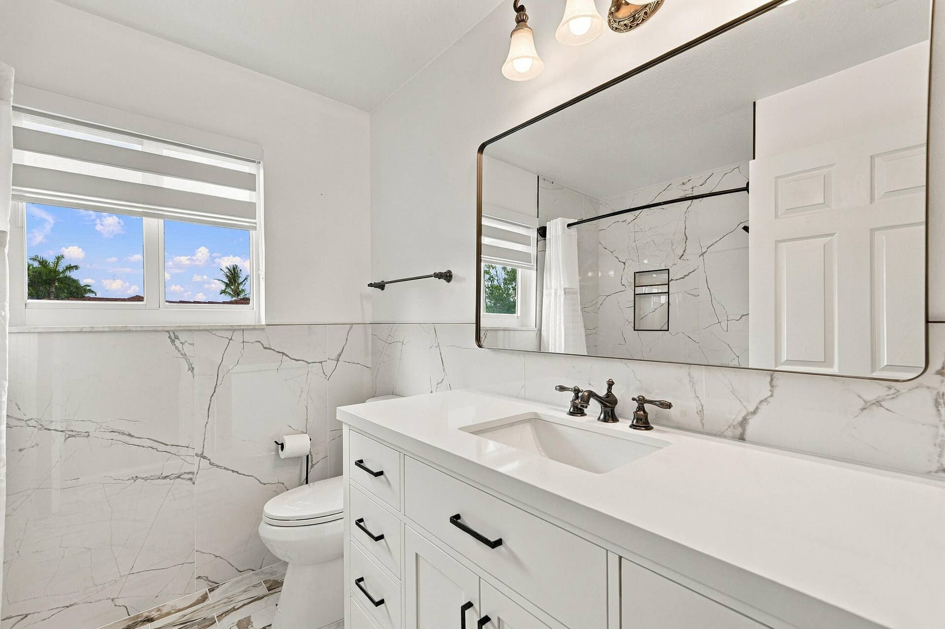 1020 Lavender Circle, Weston, FL 33327 Bathroom featuring a single vanity with white cabinetry, white countertop, and dark-finished hardware