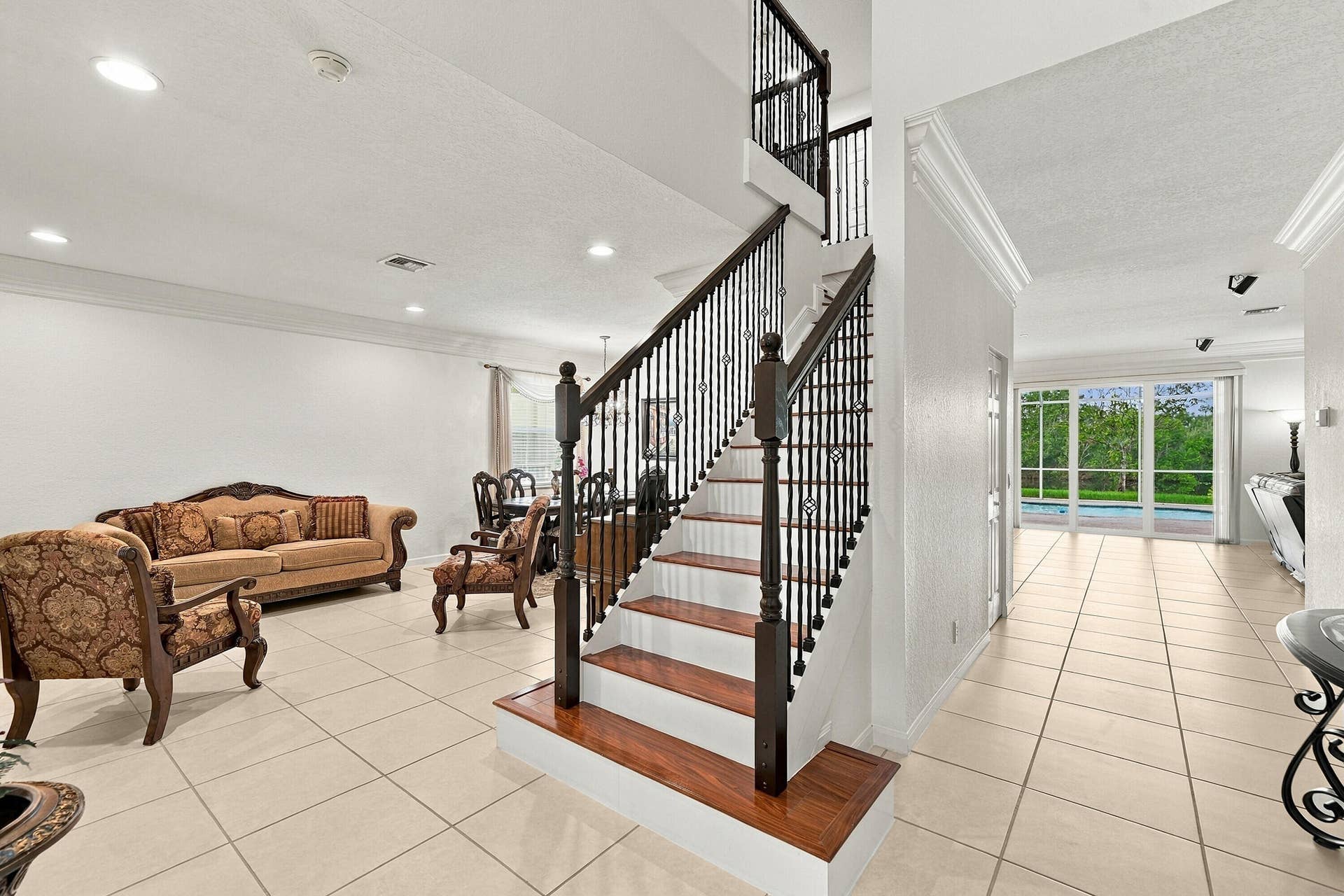 1020 Lavender Circle, Weston, FL 33327 Two-story staircase with dark wood-finish treads and balusters