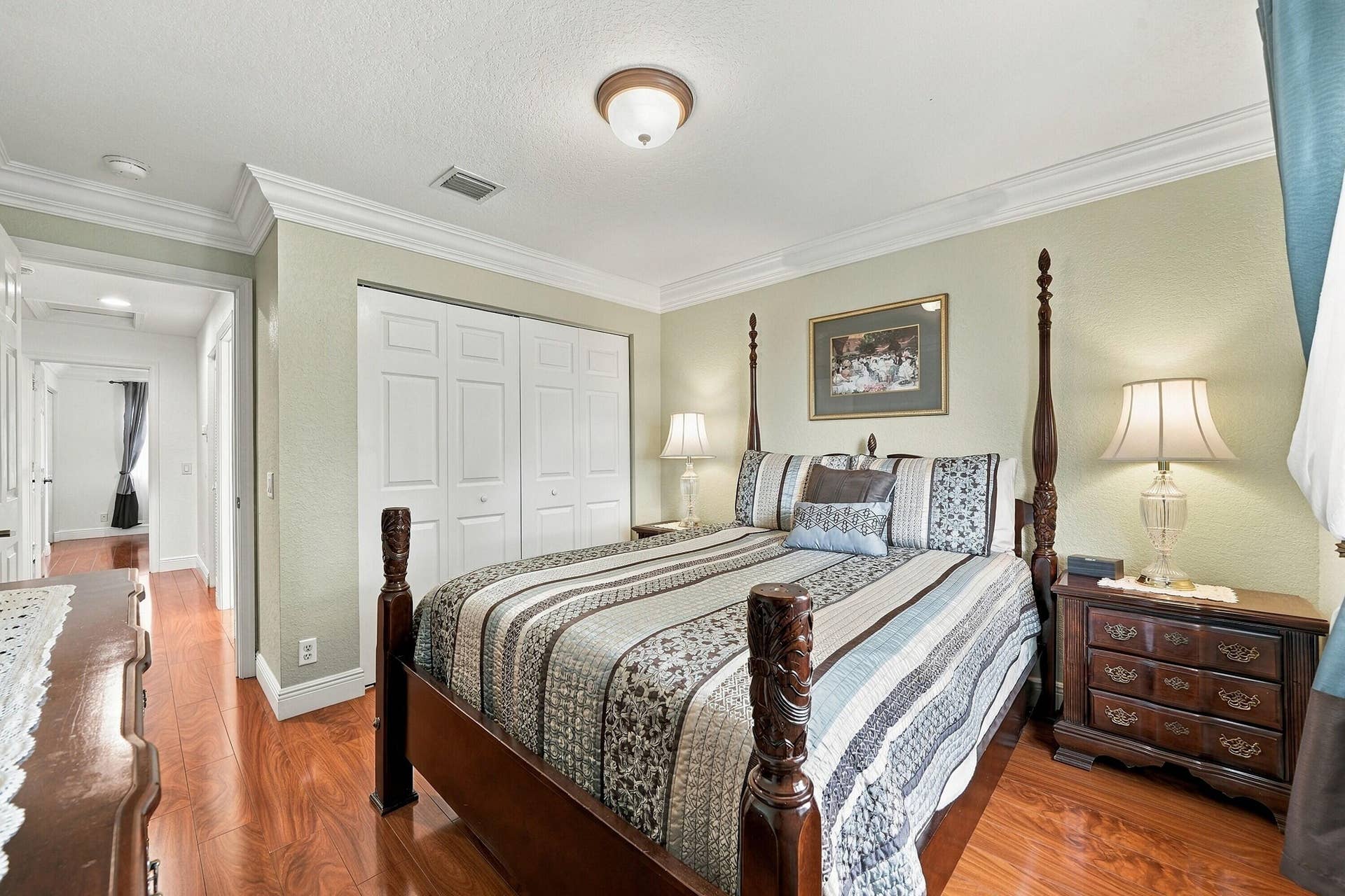1020 Lavender Circle, Weston, FL 33327 Wood-finish flooring throughout, white crown molding, and a ceiling-mounted light fixture