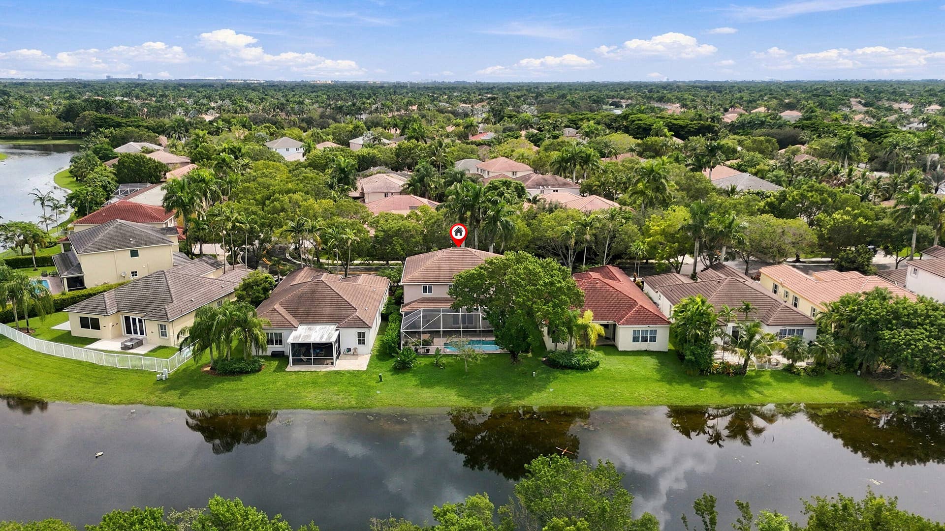 1020 Lavender Circle, Weston, FL 33327 Waterfront property featuring a screened-in patio, private pool, and mature landscaping