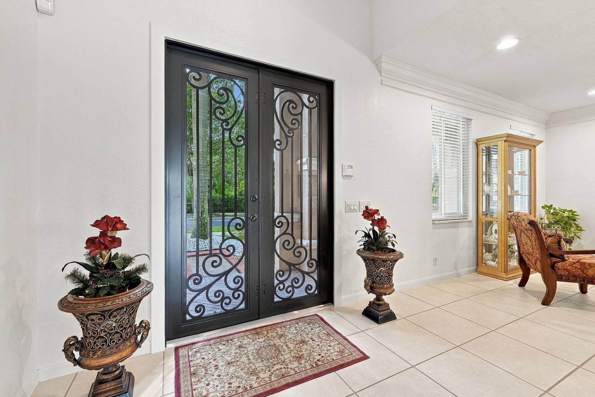 1020 Lavender Circle, Weston, FL 33327 Double entry doors with intricate wrought iron detailing, recessed lighting, crown molding, and tiled flooring