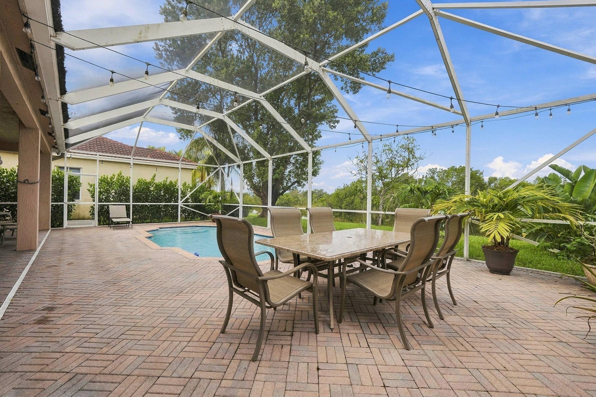 1020 Lavender Circle, Weston, FL 33327 Screened outdoor living area featuring a swimming pool, a covered patio, and brick paver decking