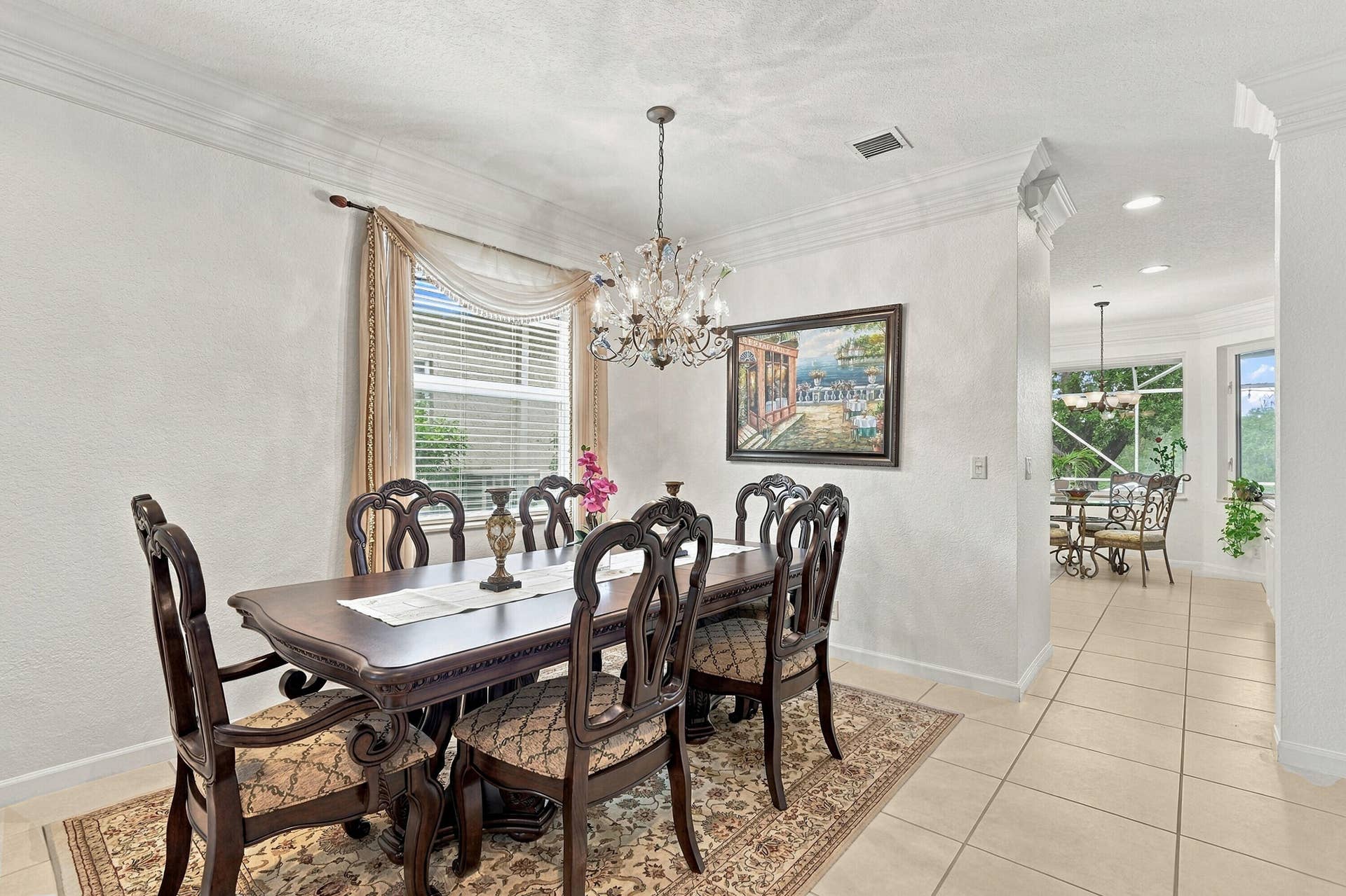 1020 Lavender Circle, Weston, FL 33327 Crown molding, decorative window treatments, elegant chandelier, and light-toned tile flooring