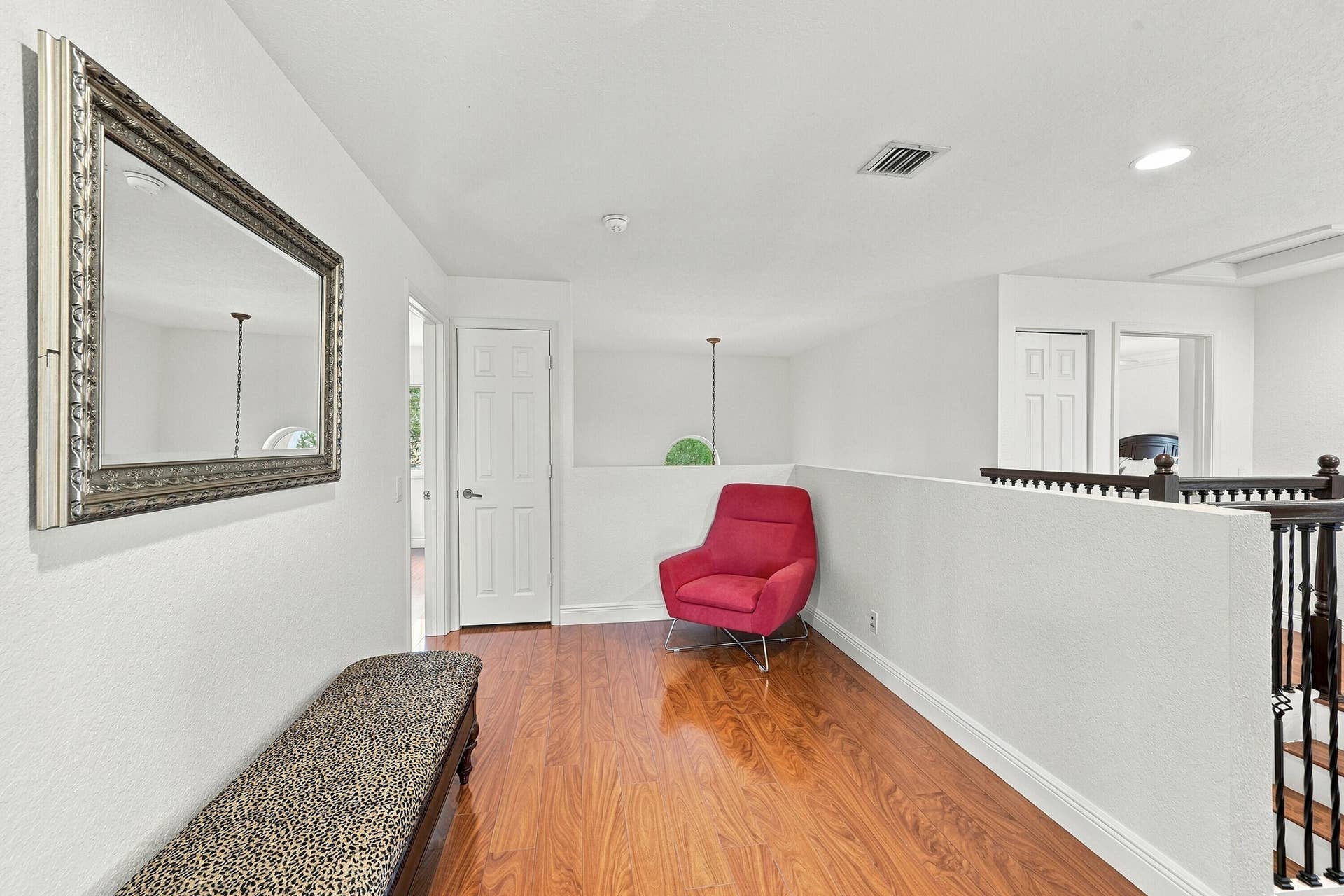 1020 Lavender Circle, Weston, FL 33327 Wood-finish flooring throughout, bright white walls, and a staircase with dark wood balusters
