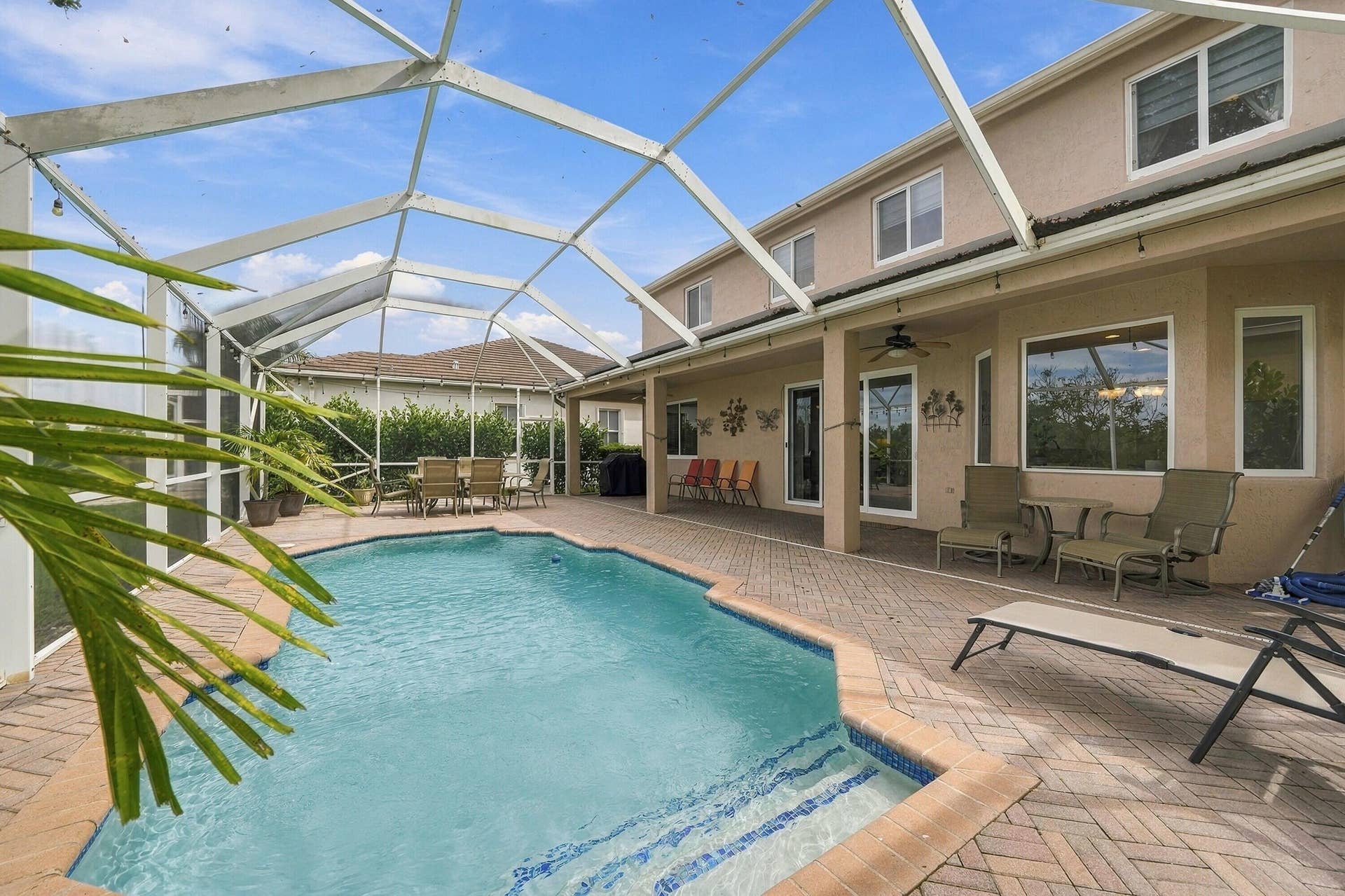 1020 Lavender Circle, Weston, FL 33327 Screened lanai with arched glass ceiling and aluminum framing overlooking resort-style saltwater pool