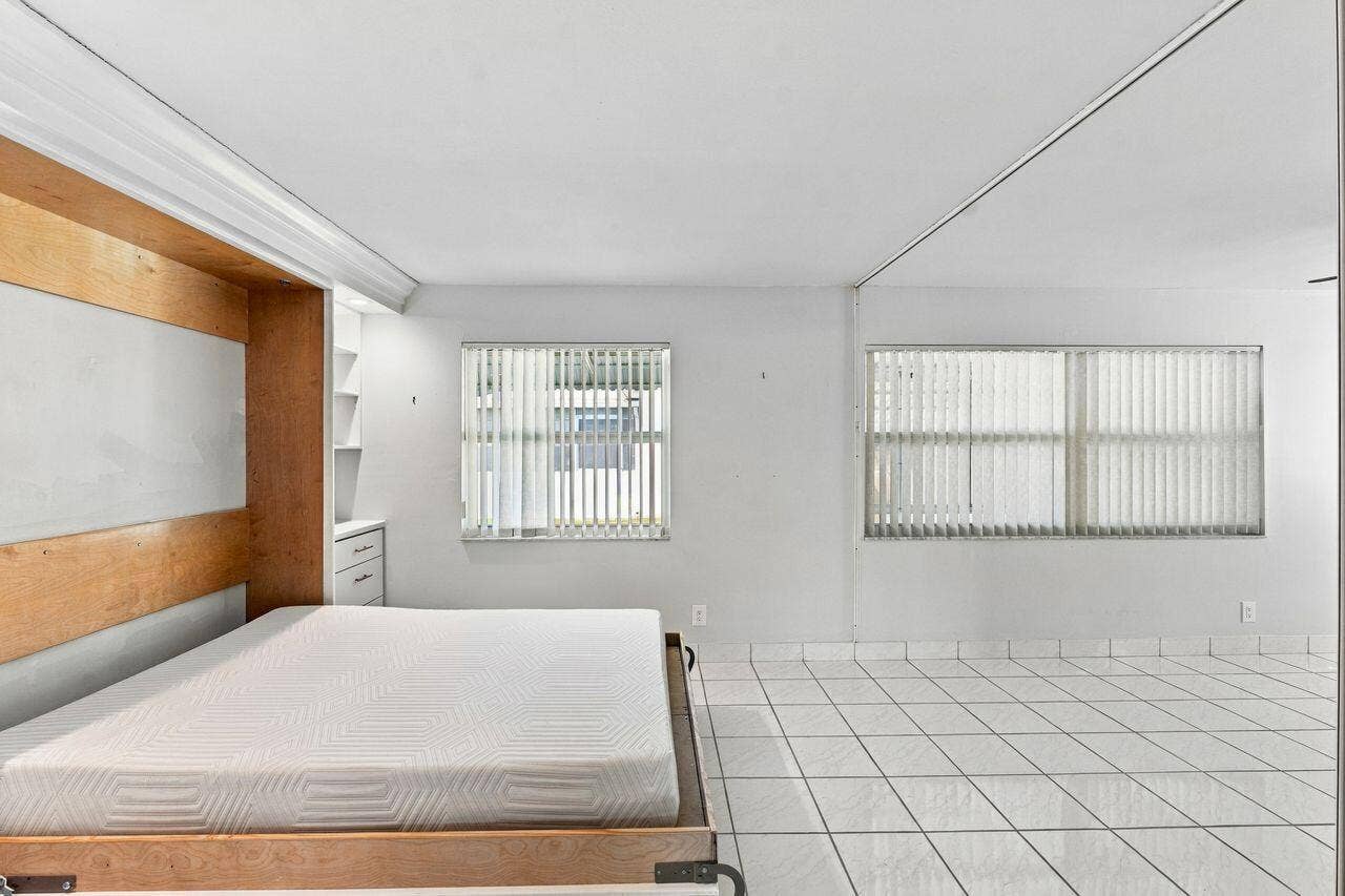 1003 SW 17th Street, Boynton Beach, FL 33426 Gorgeous Murphy bed with built-in shelving and recessed lighting, creates a flexible space
