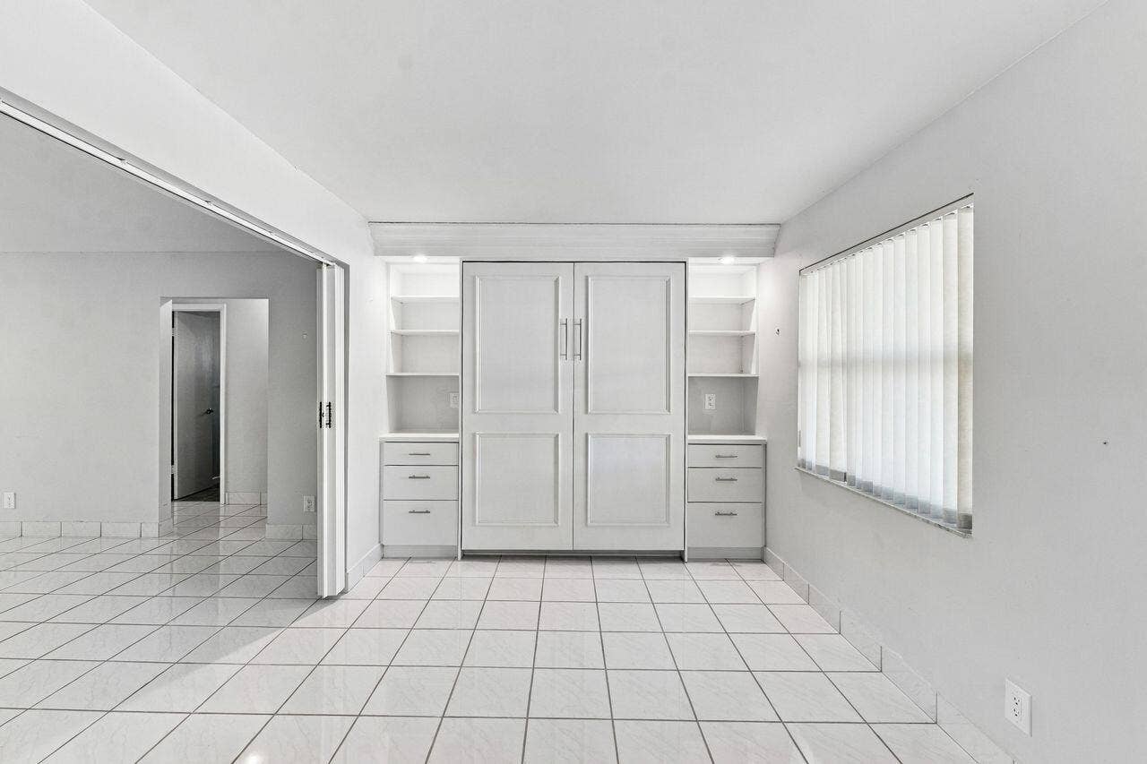 1003 SW 17th Street, Boynton Beach, FL 33426 Large living space with a gorgeous Murphy Bed & Bookshelves for extra sleeping accommodations