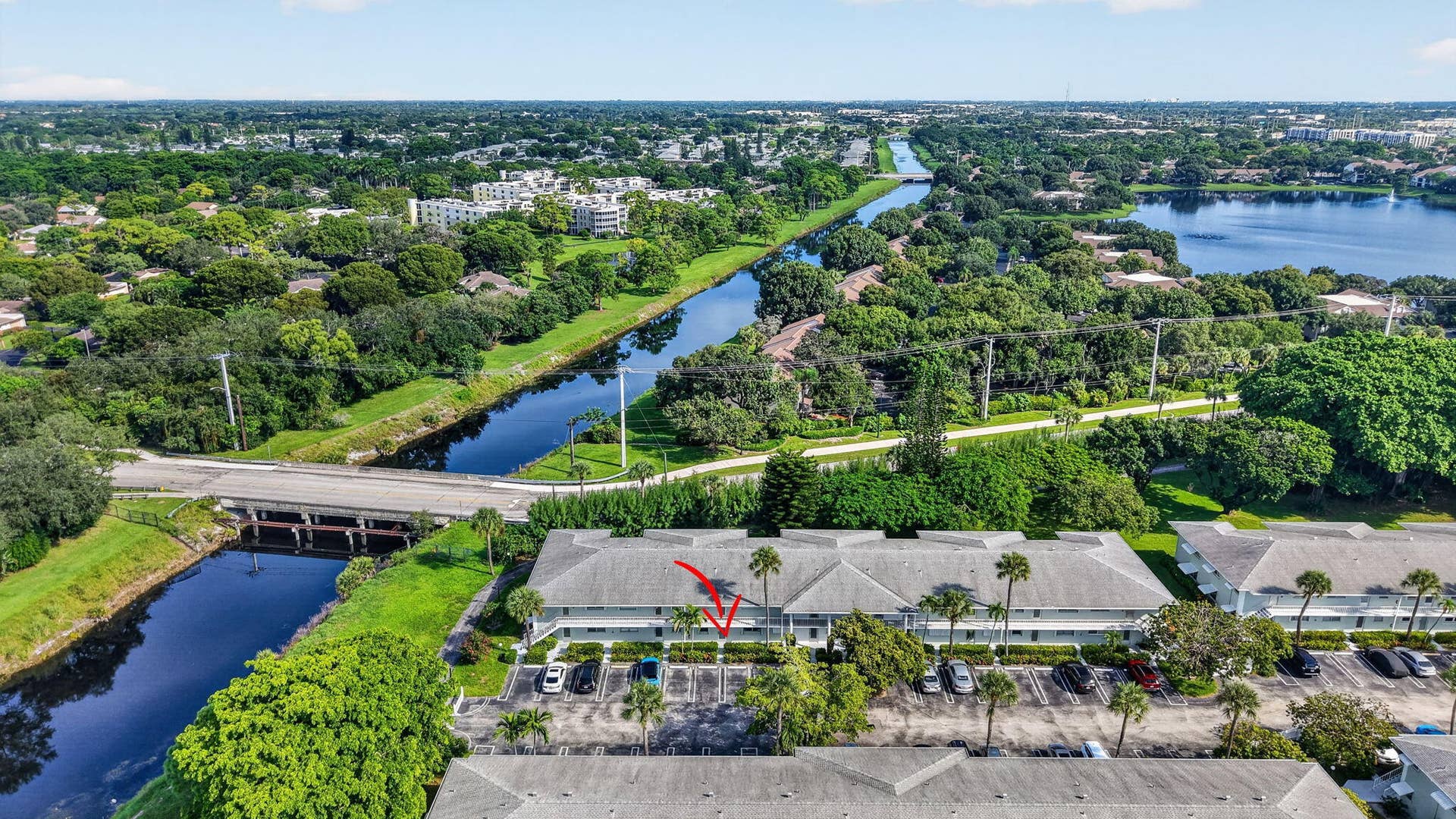 2320 SW 22nd Avenue, #211, Delray Beach, FL 33445 Building exterior surrounded by mature trees and lush landscaping