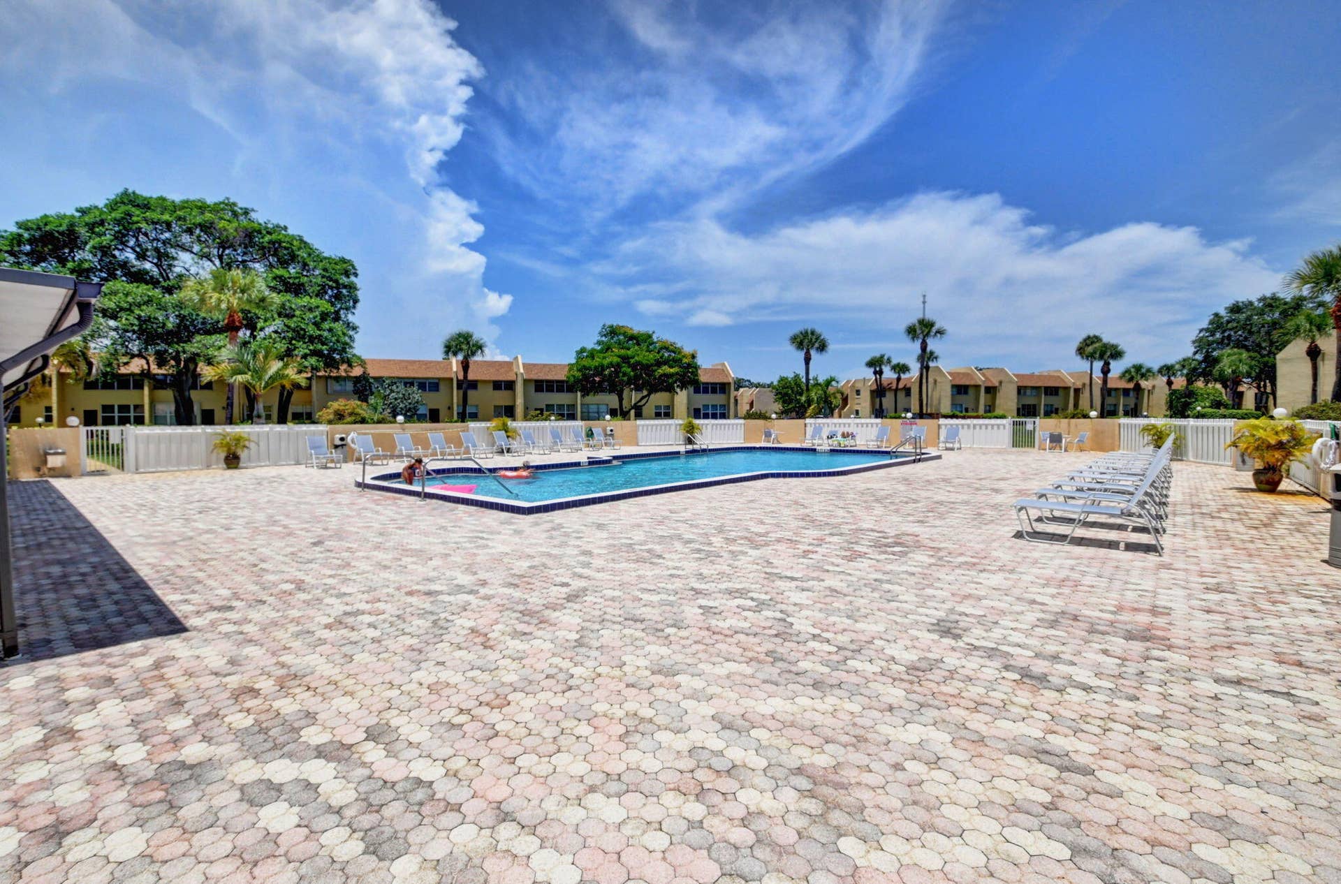 2320 SW 22nd Avenue, #211, Delray Beach, FL 33445 Expansive paver patio surrounding the swimming pool