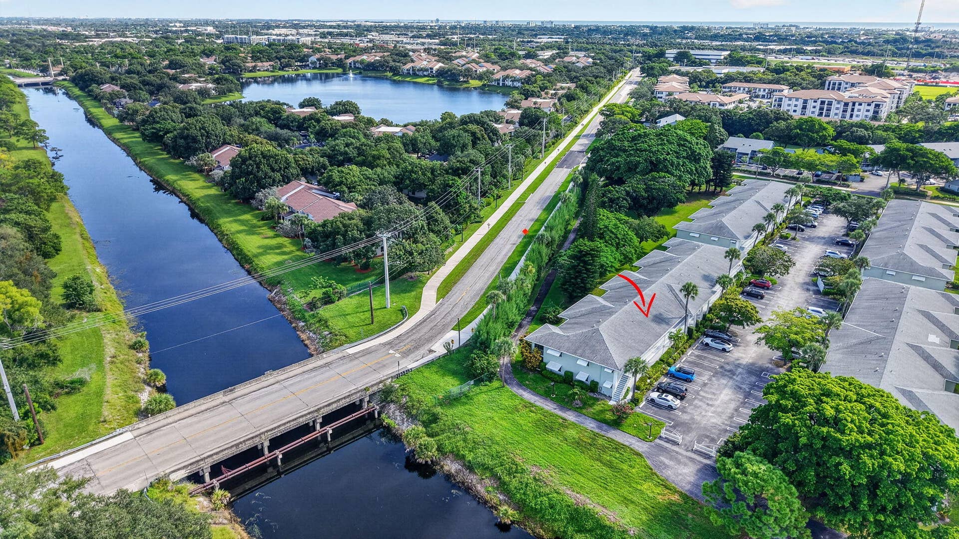 2320 SW 22nd Avenue, #211, Delray Beach, FL 33445 Aerial view showcasing the property's prime location along the tree-lined waterway