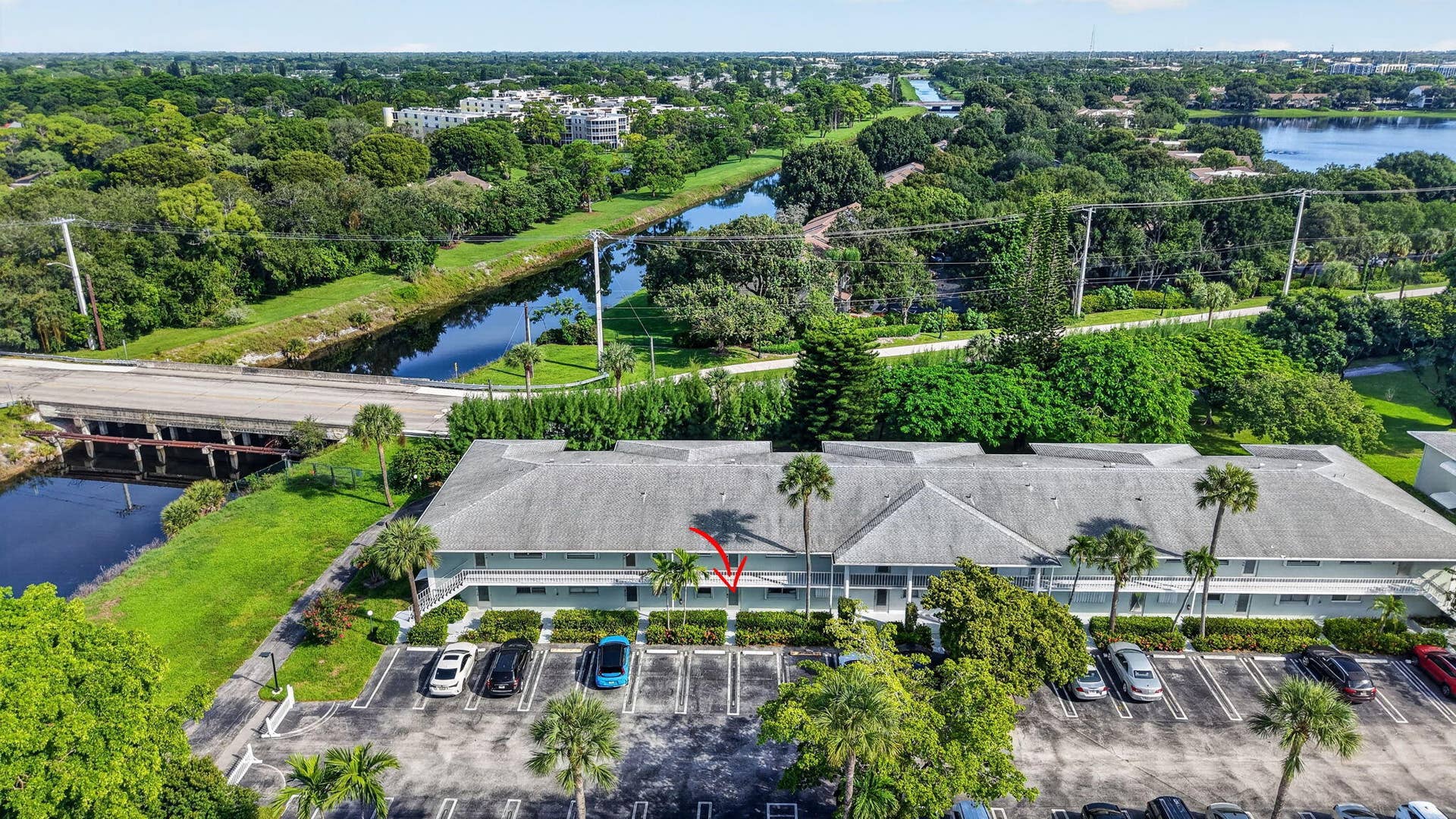2320 SW 22nd Avenue, #211, Delray Beach, FL 33445 Building exterior surrounded by mature trees and lush landscaping