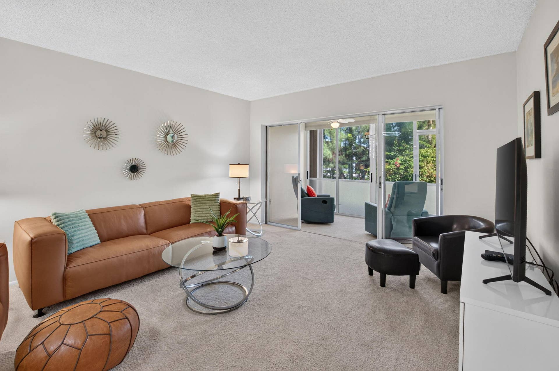 2320 SW 22nd Avenue, #211, Delray Beach, FL 33445 Bright, open living area featuring neutral wall finishes, and large sliding glass doors with natural light