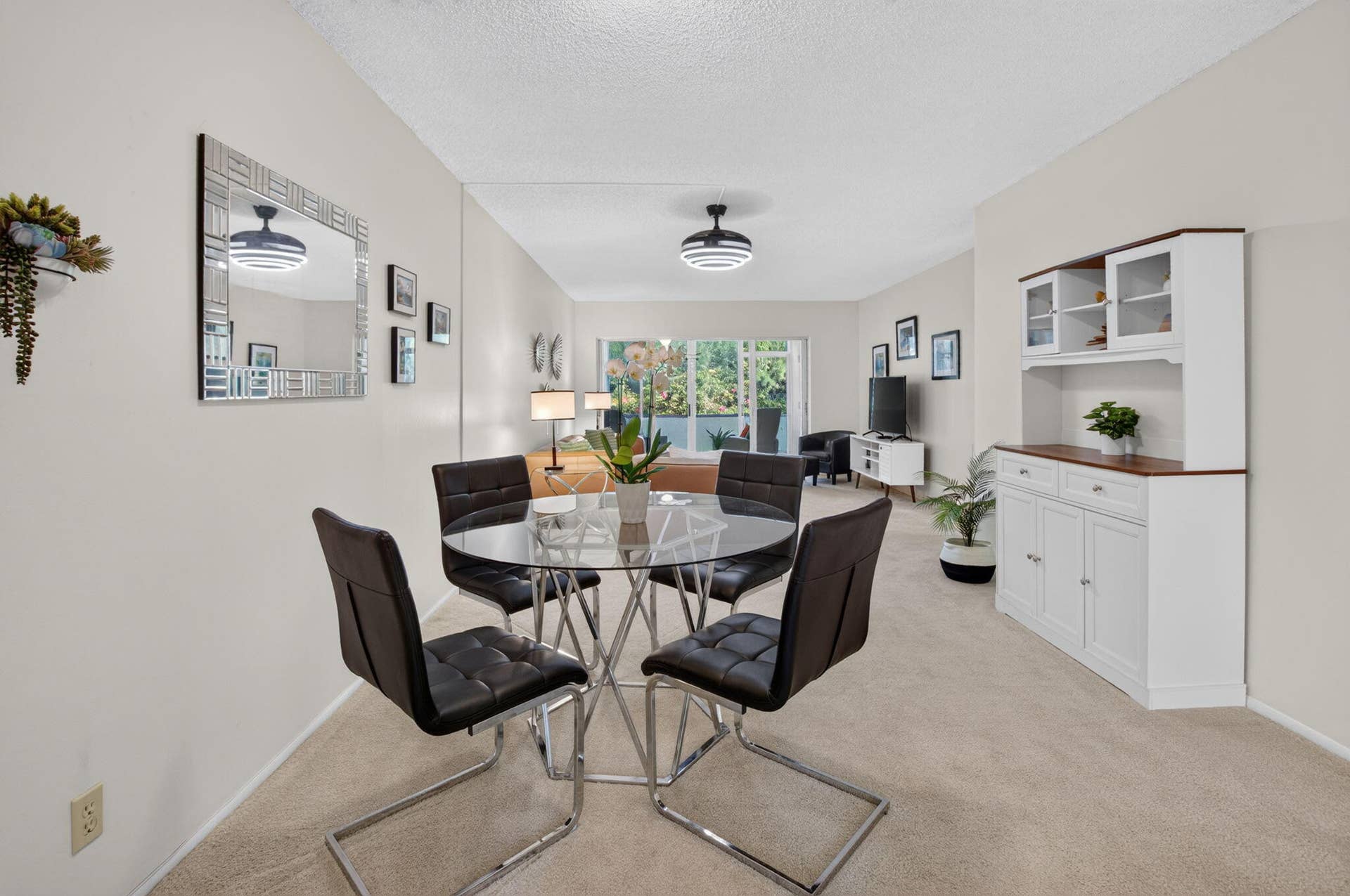 2320 SW 22nd Avenue, #211, Delray Beach, FL 33445 Open-concept living area with neutral carpeting and light-toned walls
