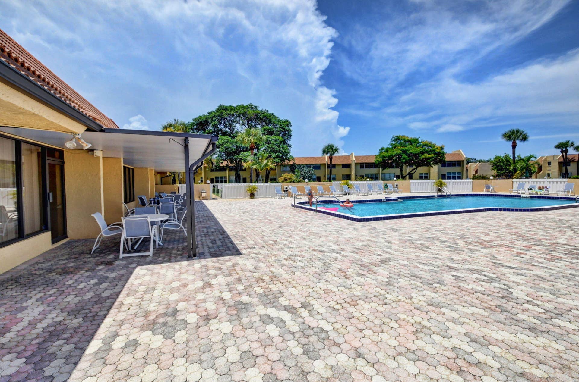 2320 SW 22nd Avenue, #211, Delray Beach, FL 33445 Swimming pool with a tile border, surrounded by a paver patio