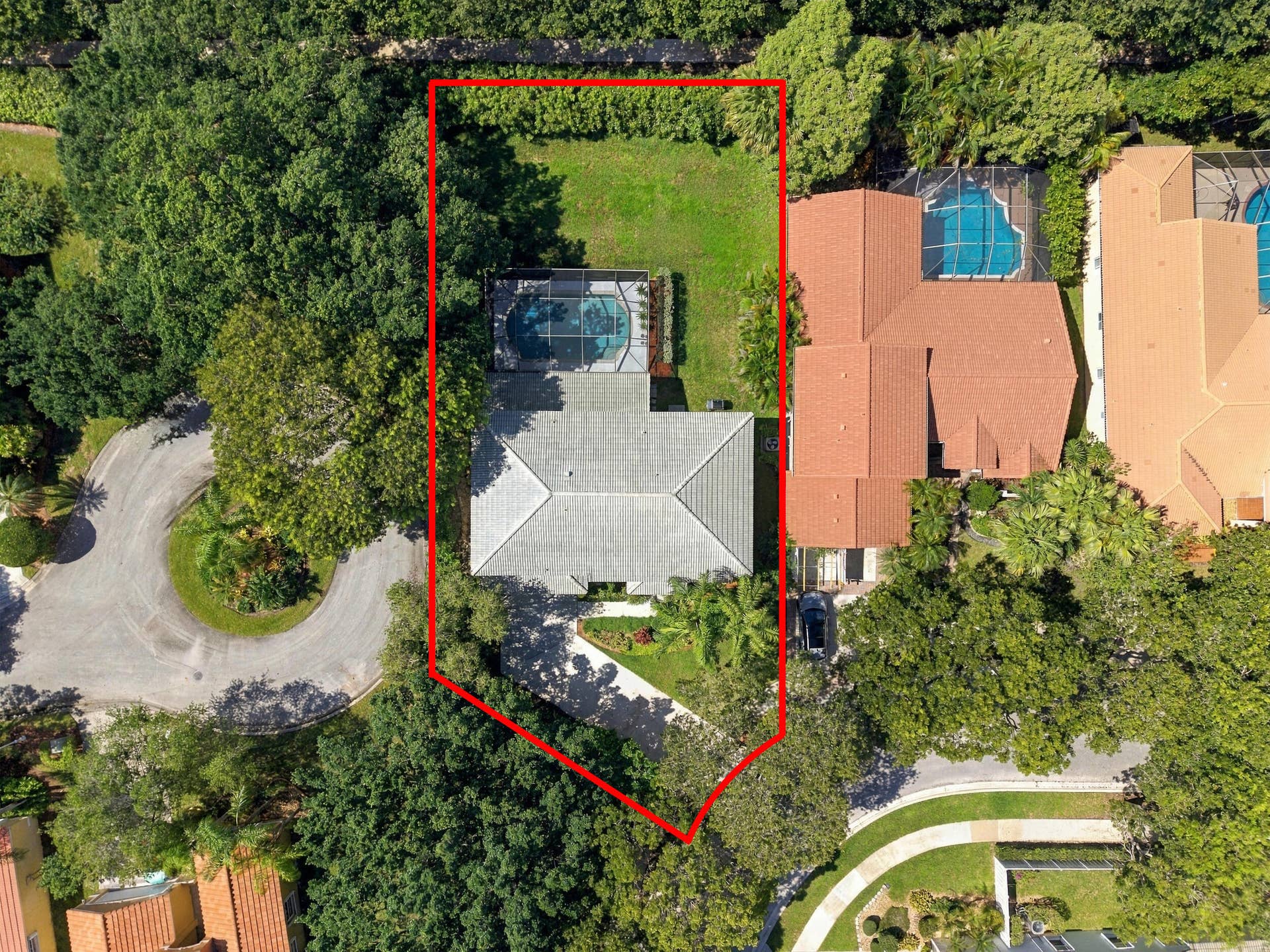 1985 Landing Way, Weston, FL 33326 Residential property with a screened swimming pool, adjacent green space, and mature trees
