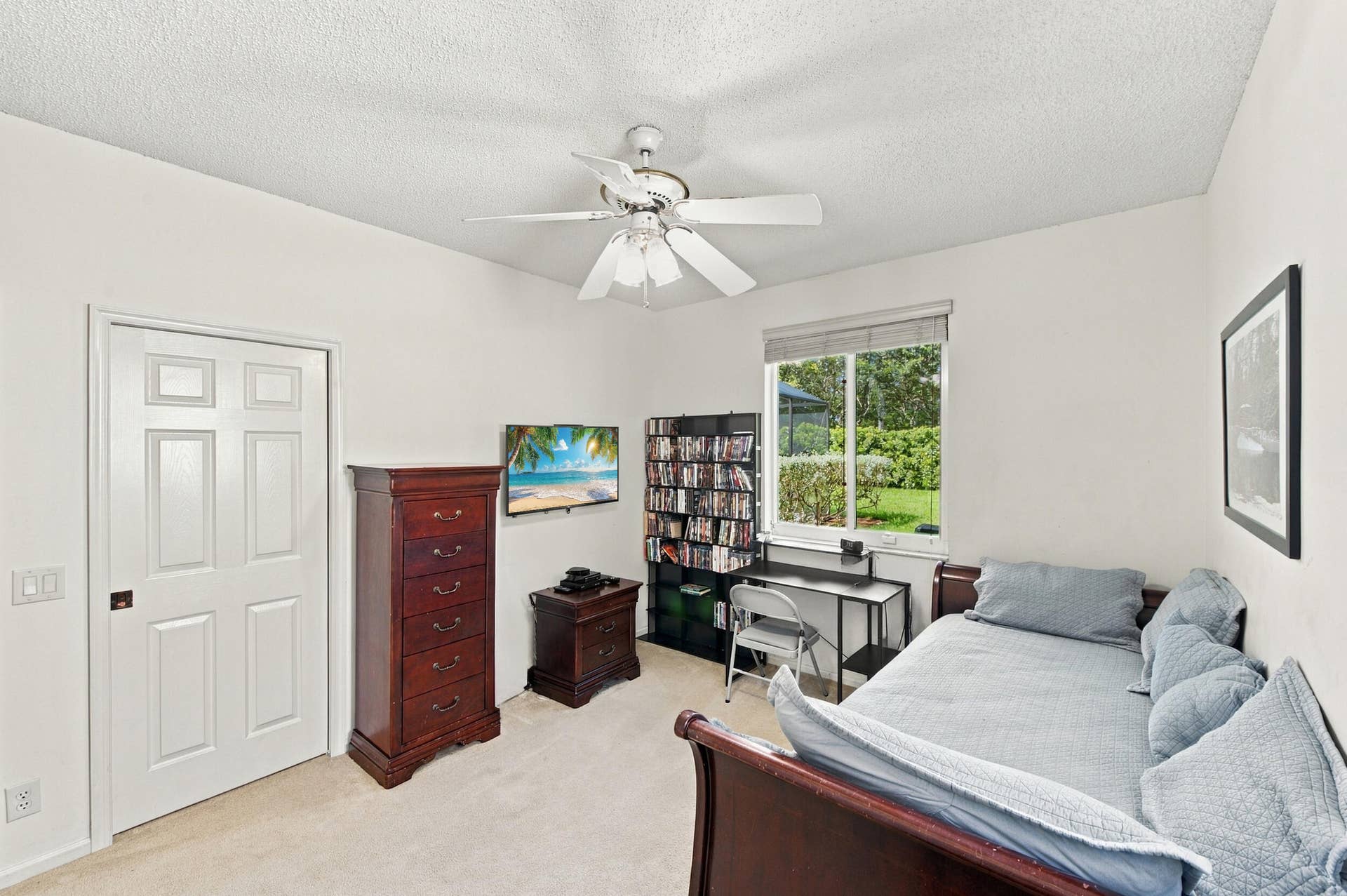 1985 Landing Way, Weston, FL 33326 Vaulted ceiling, ceiling fan, white six-panel door, window with outdoor scenery, and carpet flooring