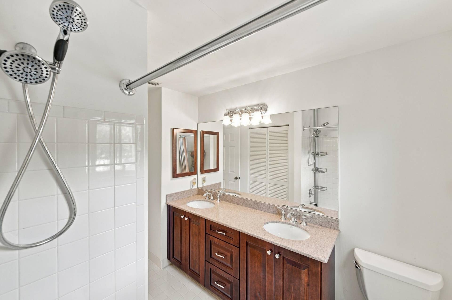 1985 Landing Way, Weston, FL 33326 Dual vanity with undermount sinks, wood-finish cabinetry, and a full-width mirror