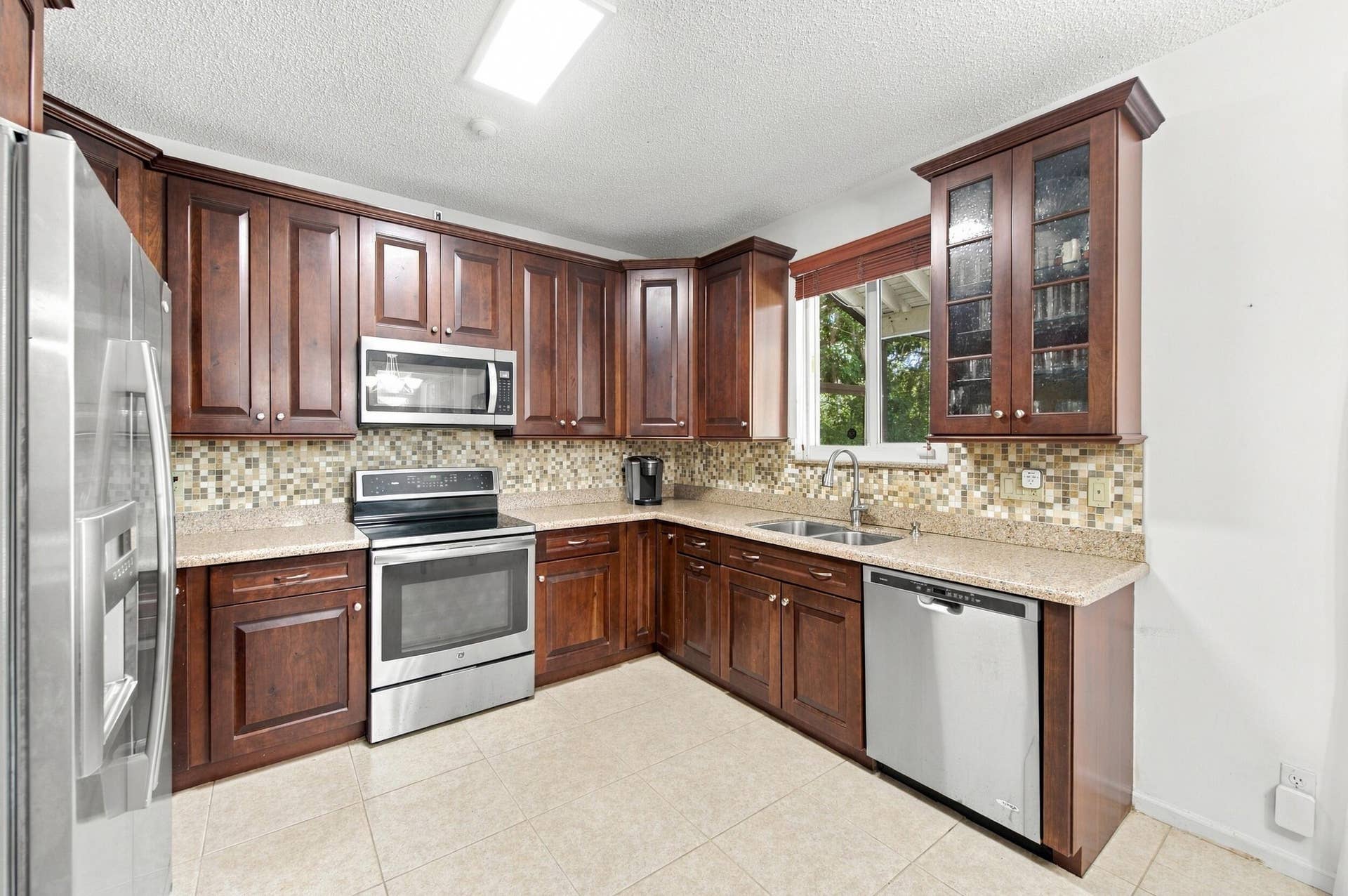 1985 Landing Way, Weston, FL 33326 Wood-finish cabinetry paired with light-toned countertops
