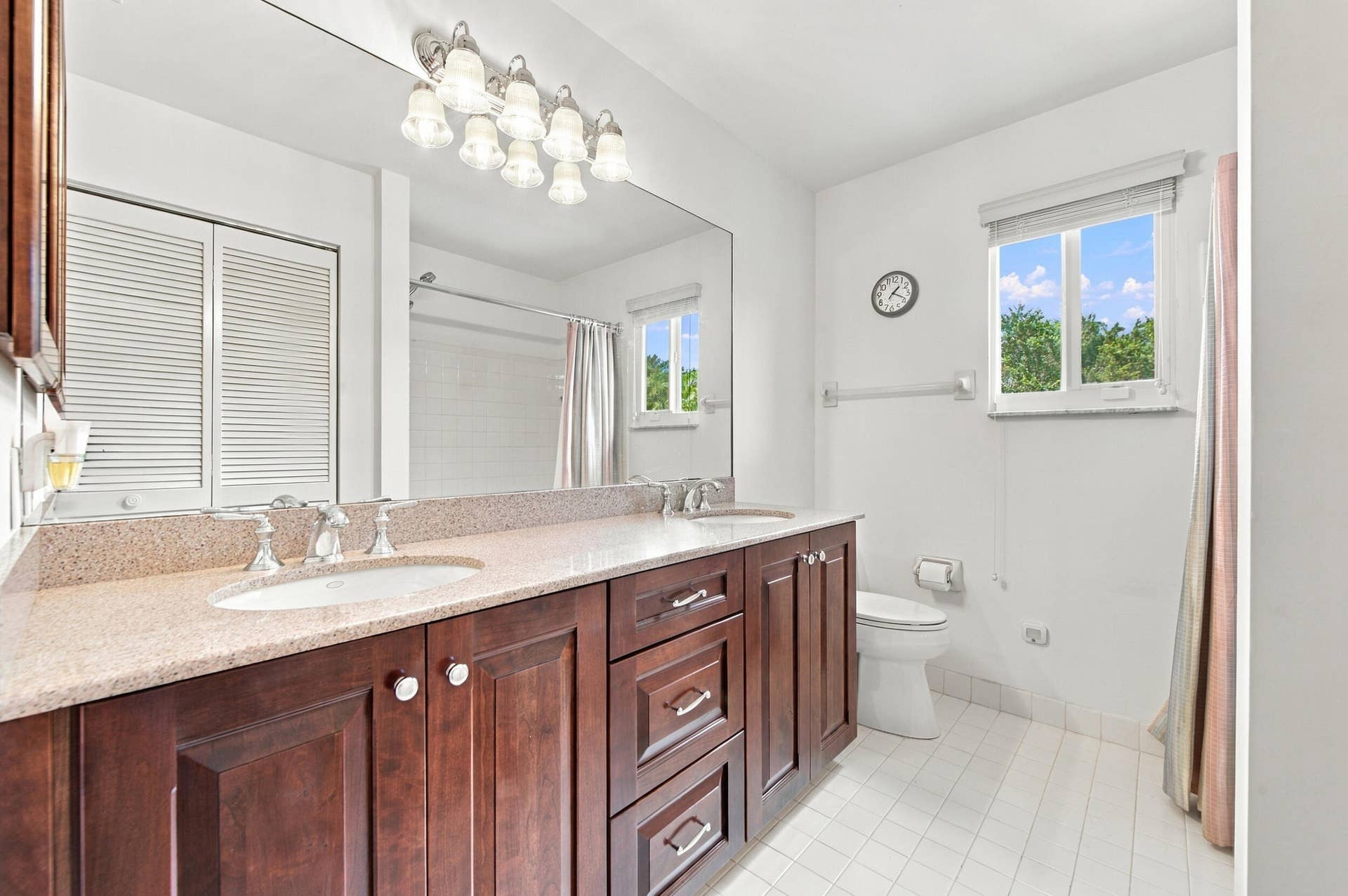1985 Landing Way, Weston, FL 33326 Double vanity with a light-toned countertop, dual undermount sinks, and chrome faucets