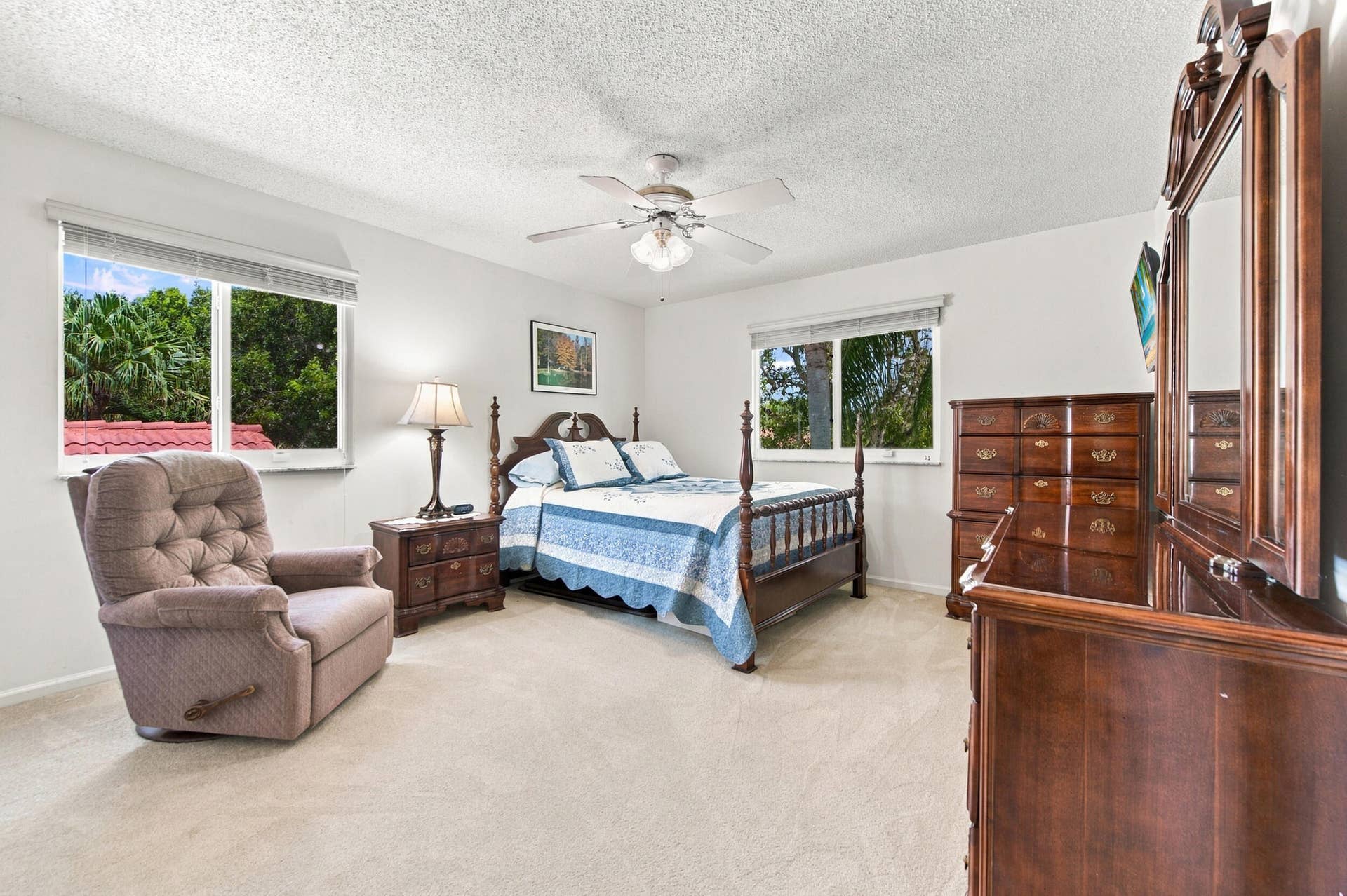1985 Landing Way, Weston, FL 33326 Textured ceiling, ceiling fan with integrated lighting, two windows with blinds, and light-colored carpeting