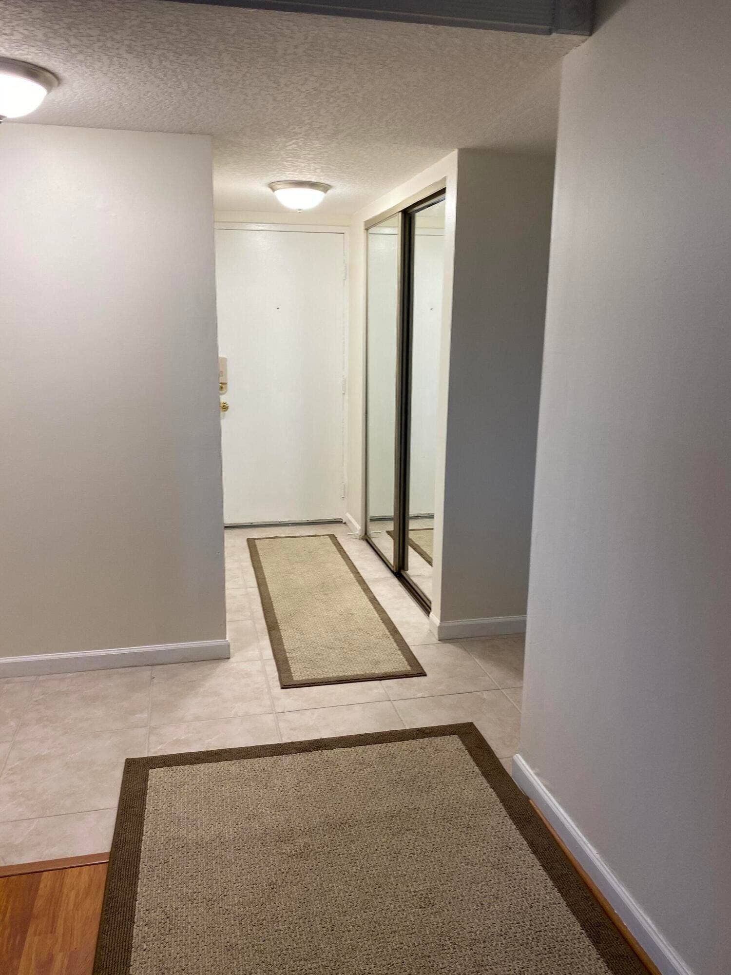 Tile flooring entry with flush-mounted ceiling lighting