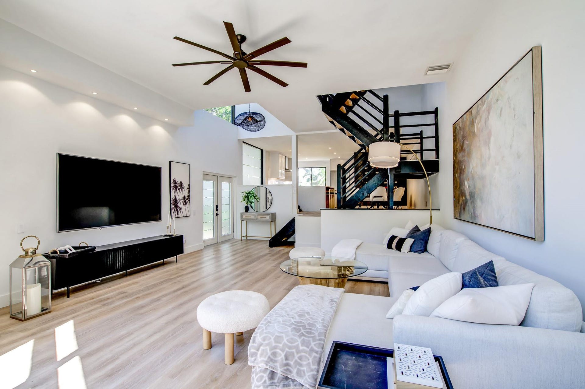 Vaulted ceilings with recessed lighting, wood-finish flooring, and a modern ceiling fan