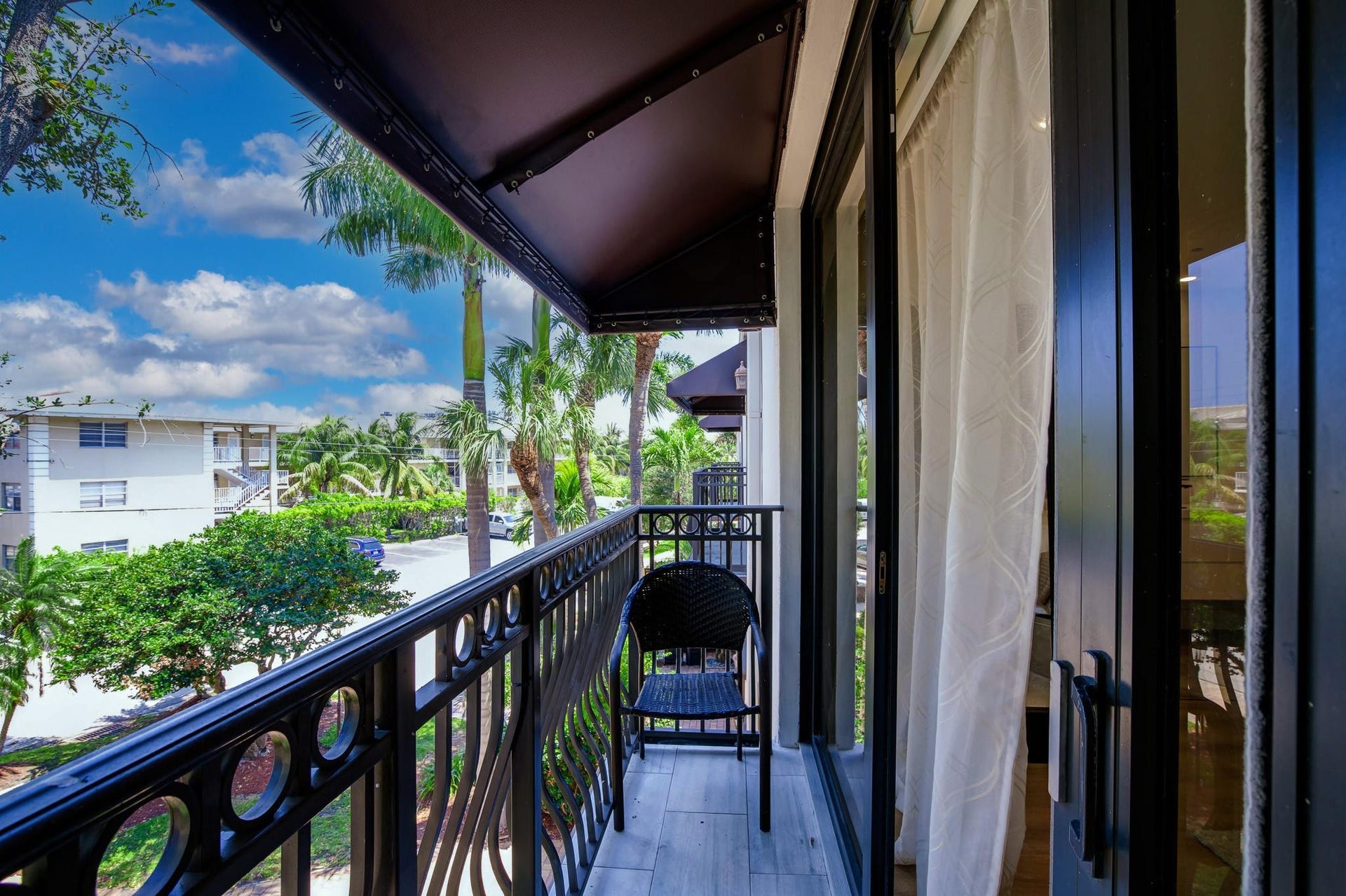 Private balcony featuring a black metal railing and wood-finish flooring