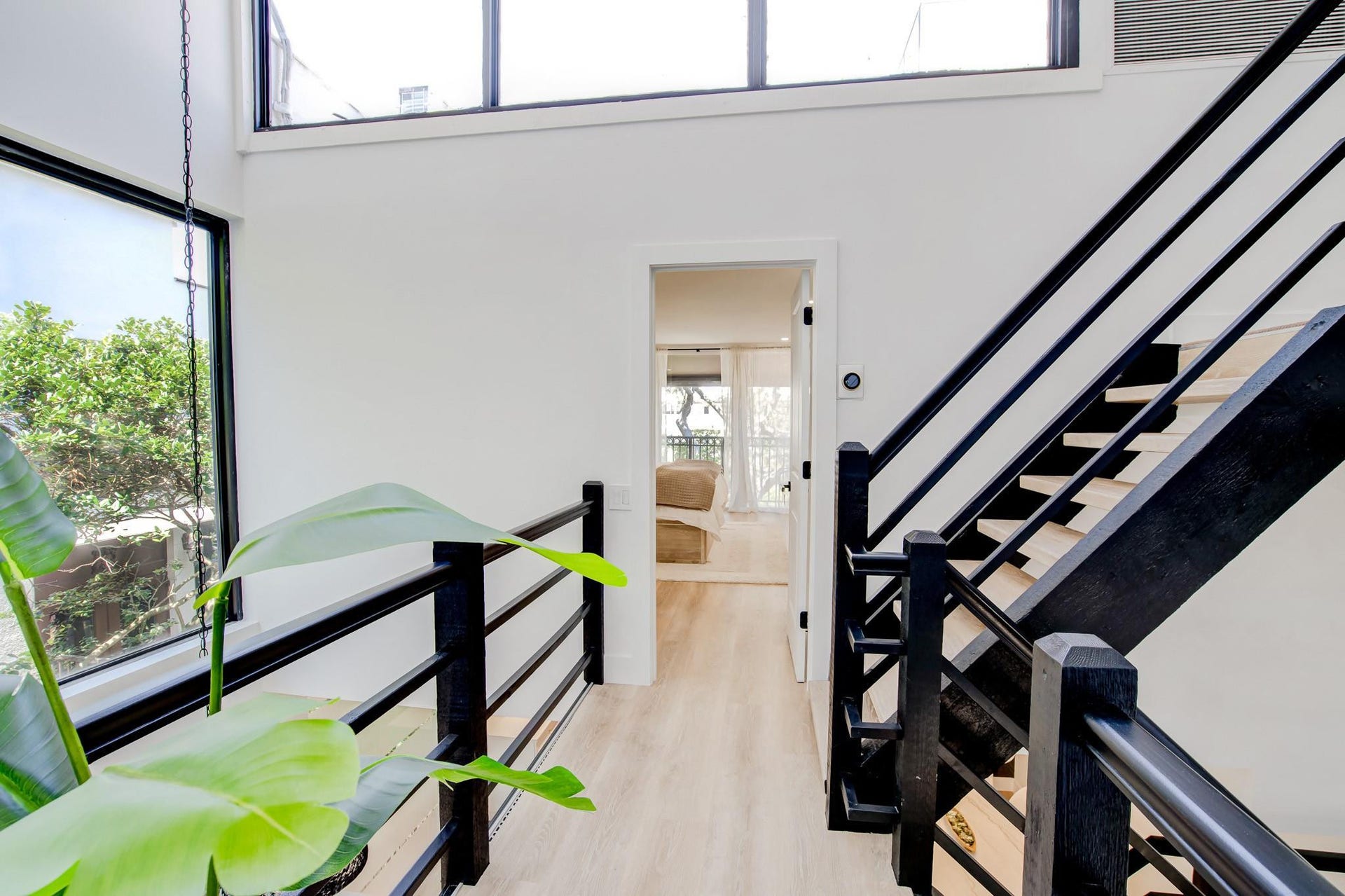 Open concept hallway with light wood-finish flooring