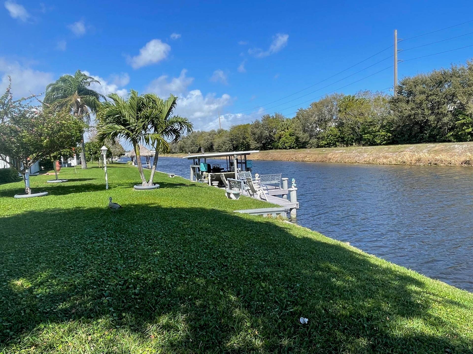 1304 SW 15TH Street, Boynton Beach, FL 33426 VIEW OF NEXT DOOR NEIGHBORS DOCK AND CANAL