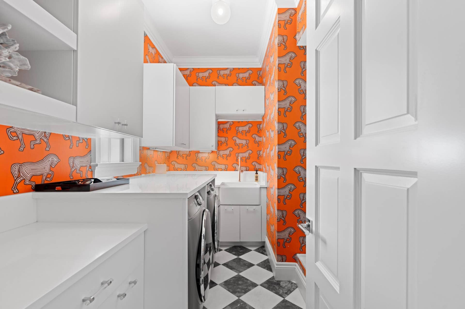 Schumacher wall paper adds a touch of glamour to this utility room